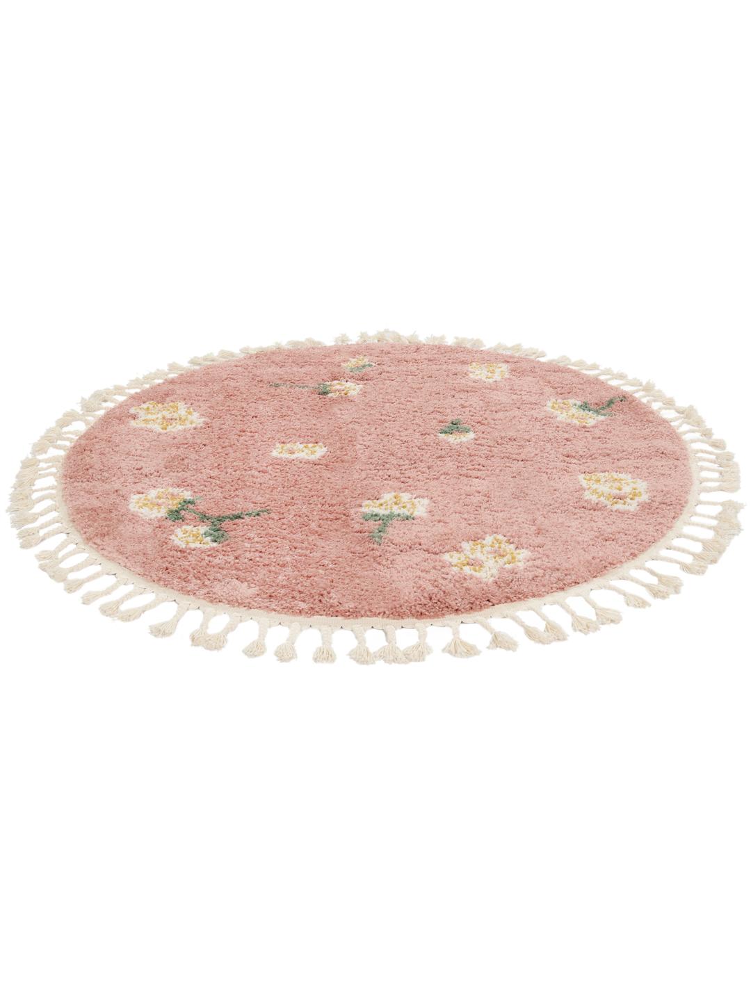 Rundt lyserødt tæppe med blomstermotiver og frinzer