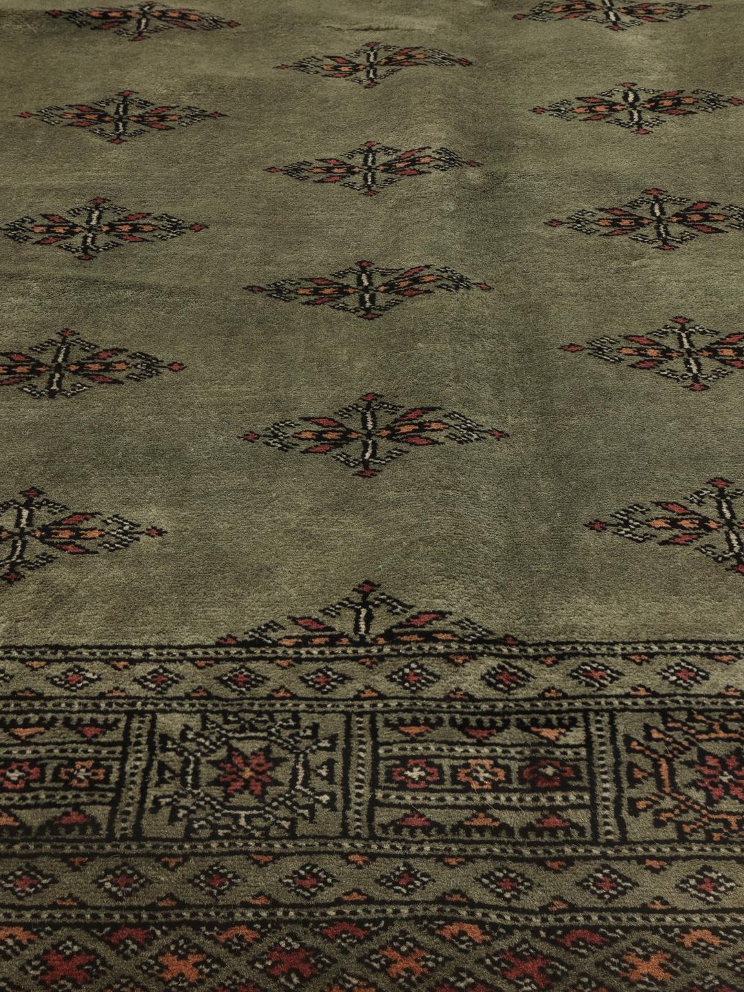 Hand-knotted Pakistan Bokhara 3ply rug in sage green with traditional motifs
