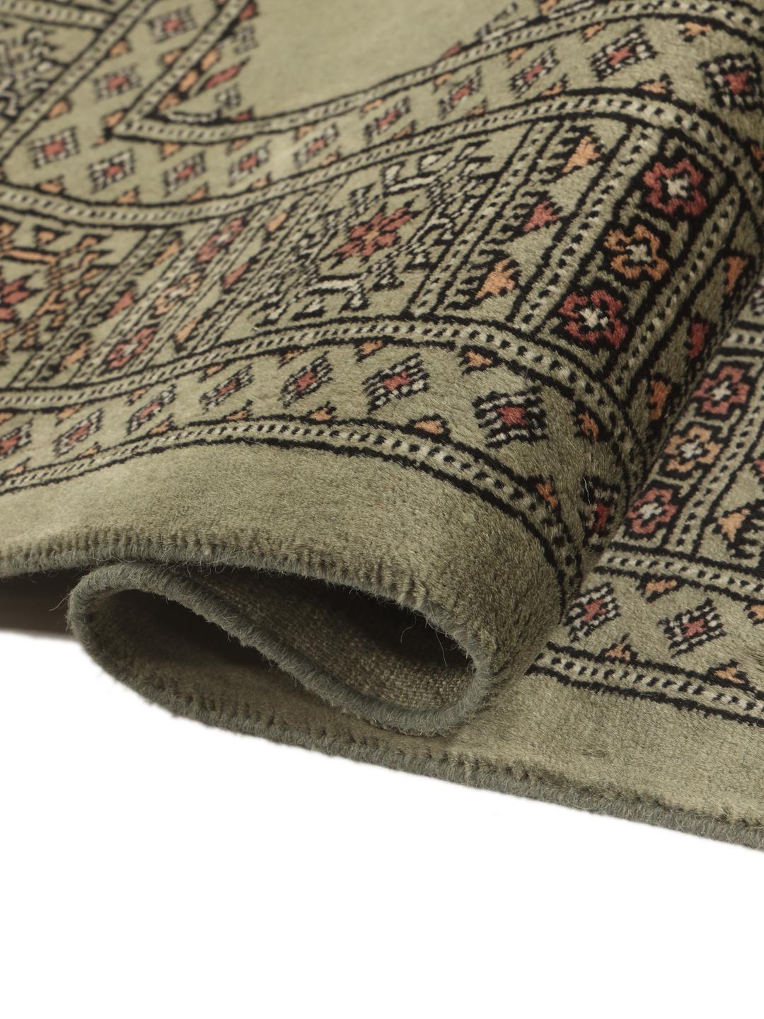 Hand-knotted Pakistan Bokhara 3ply rug in sage green with traditional motifs