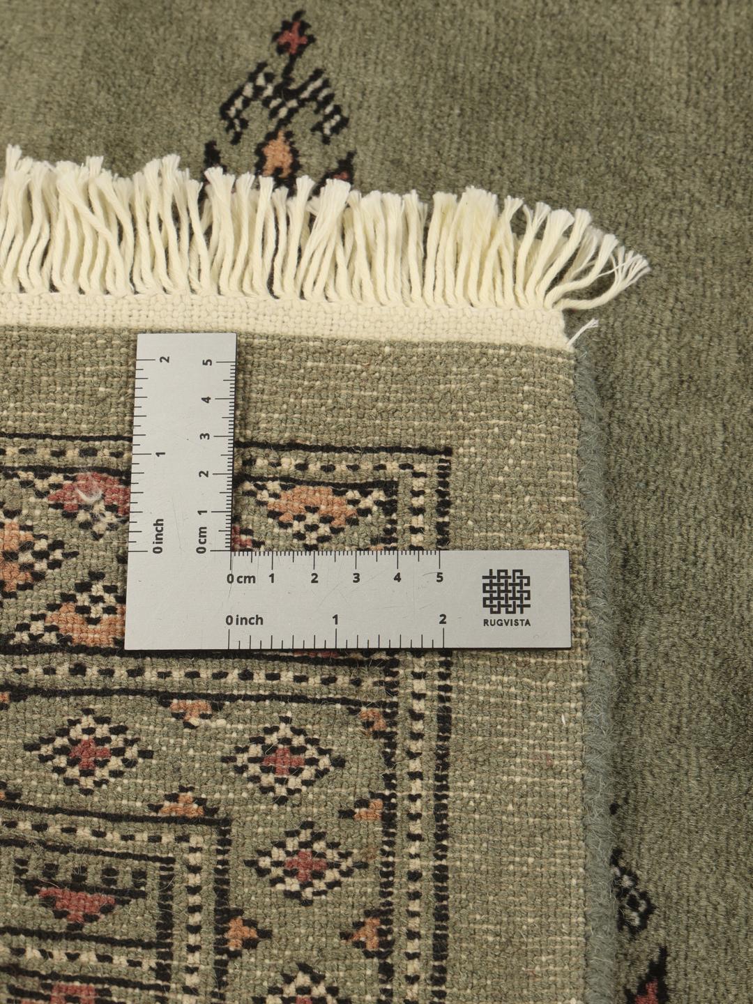 Hand-knotted Pakistan Bokhara 3ply rug in sage green with traditional motifs
