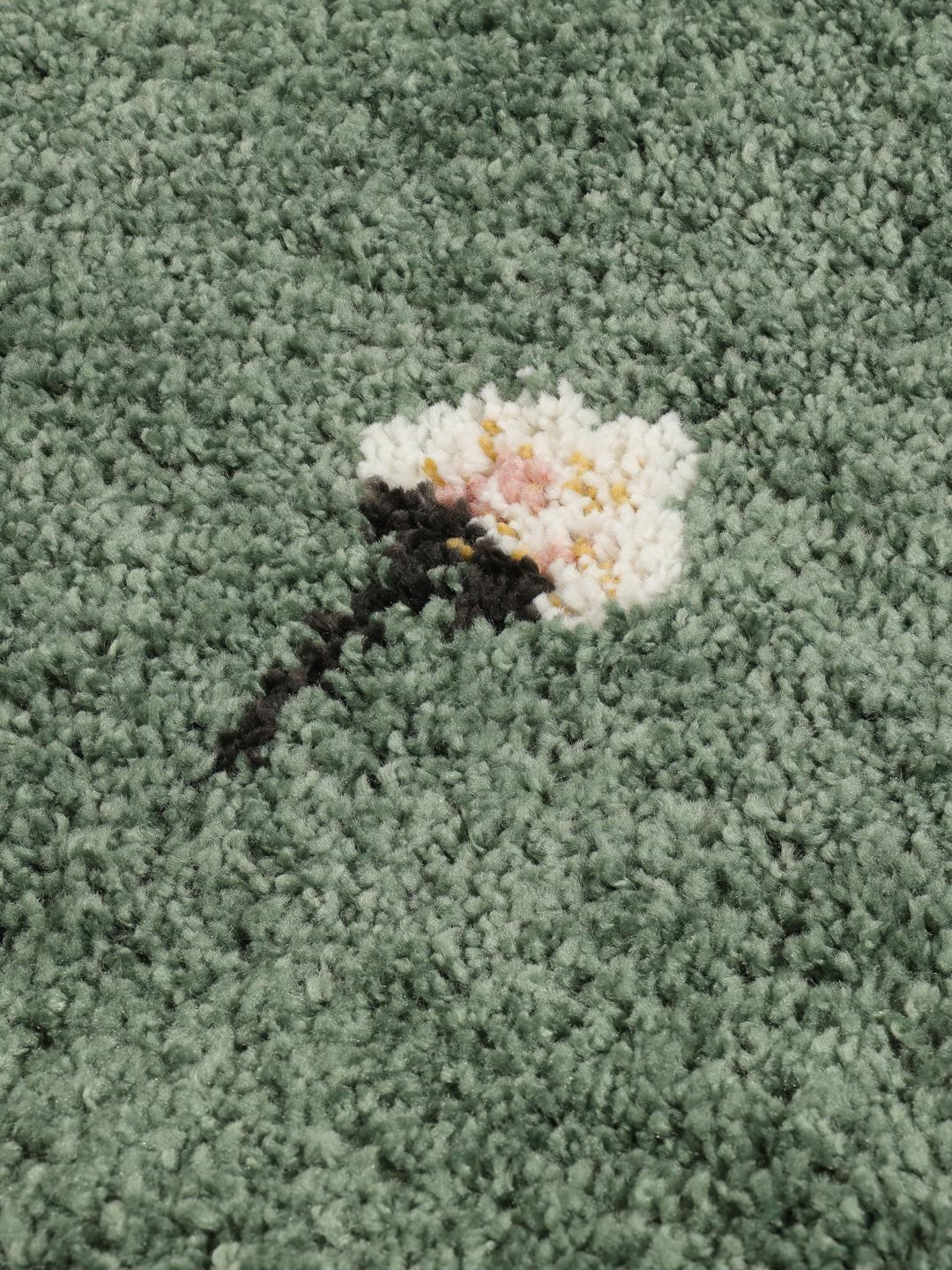 groen tapijt met bloemmotieven en franjes