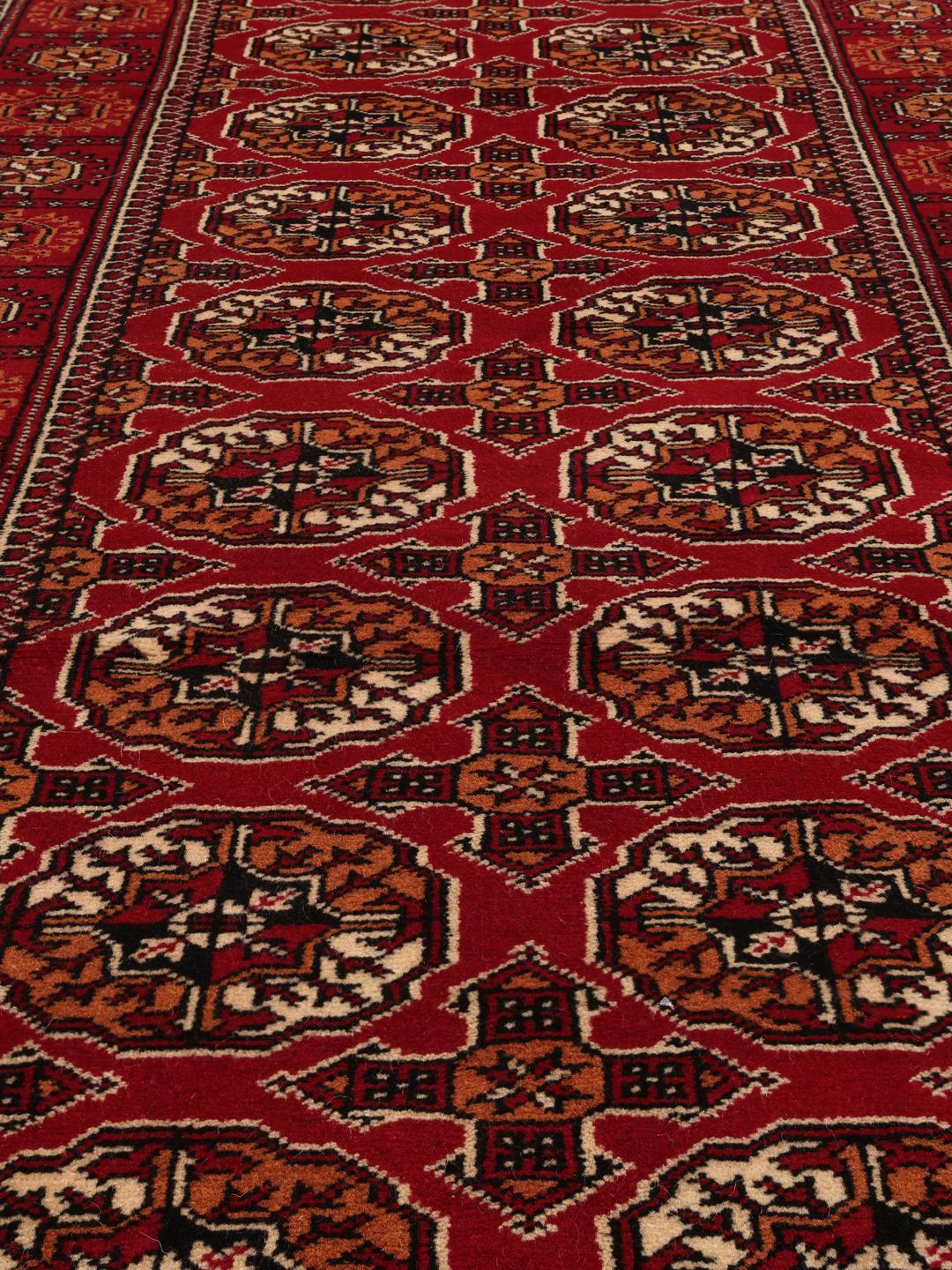 Hand-knotted red Turkaman runner with intricate geometric patterns