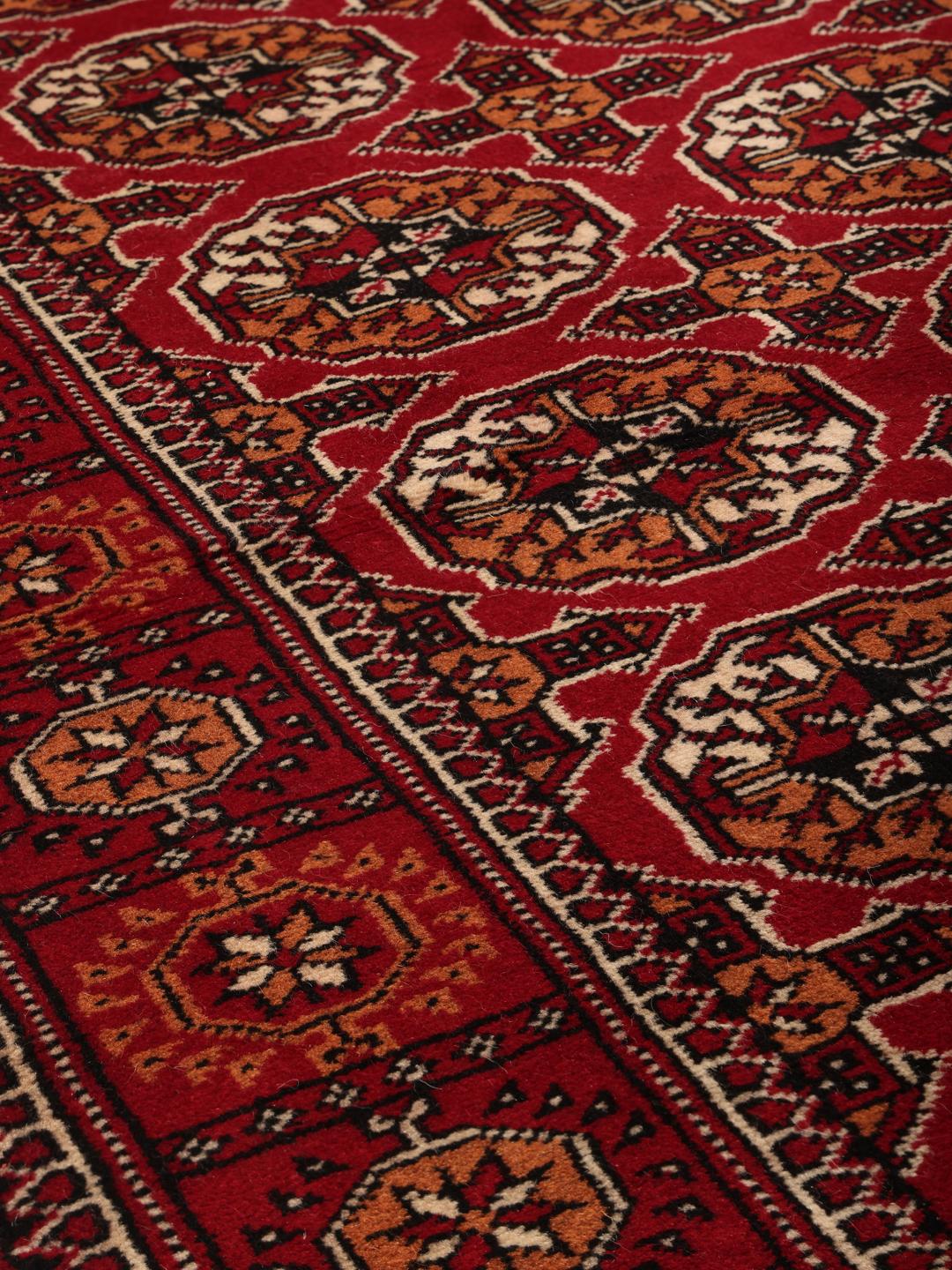 Hand-knotted red Turkaman runner with intricate geometric patterns