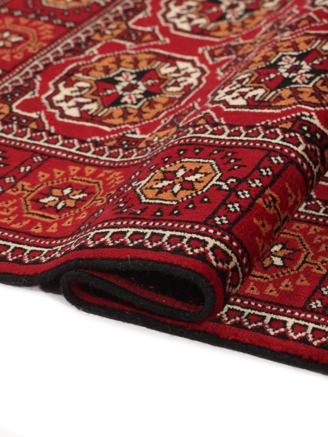 Hand-knotted red Turkaman runner with intricate geometric patterns