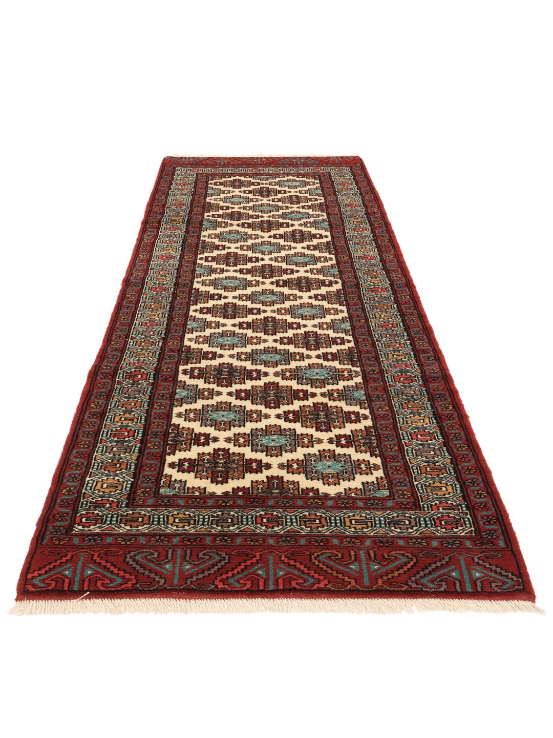 Hand-knotted Turkaman runner rug from the Middle East in red and beige tones.