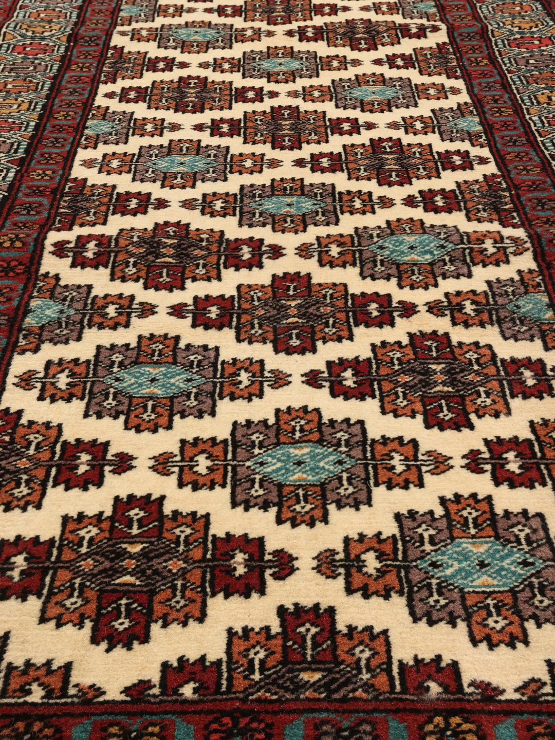 Hand-knotted Turkaman runner rug from the Middle East in red and beige tones.