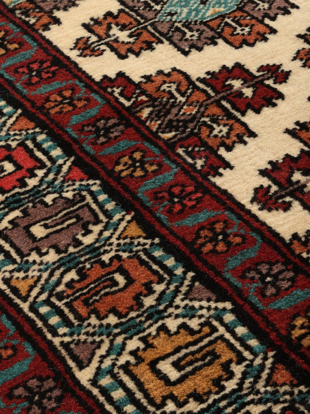 Hand-knotted Turkaman runner rug from the Middle East in red and beige tones.