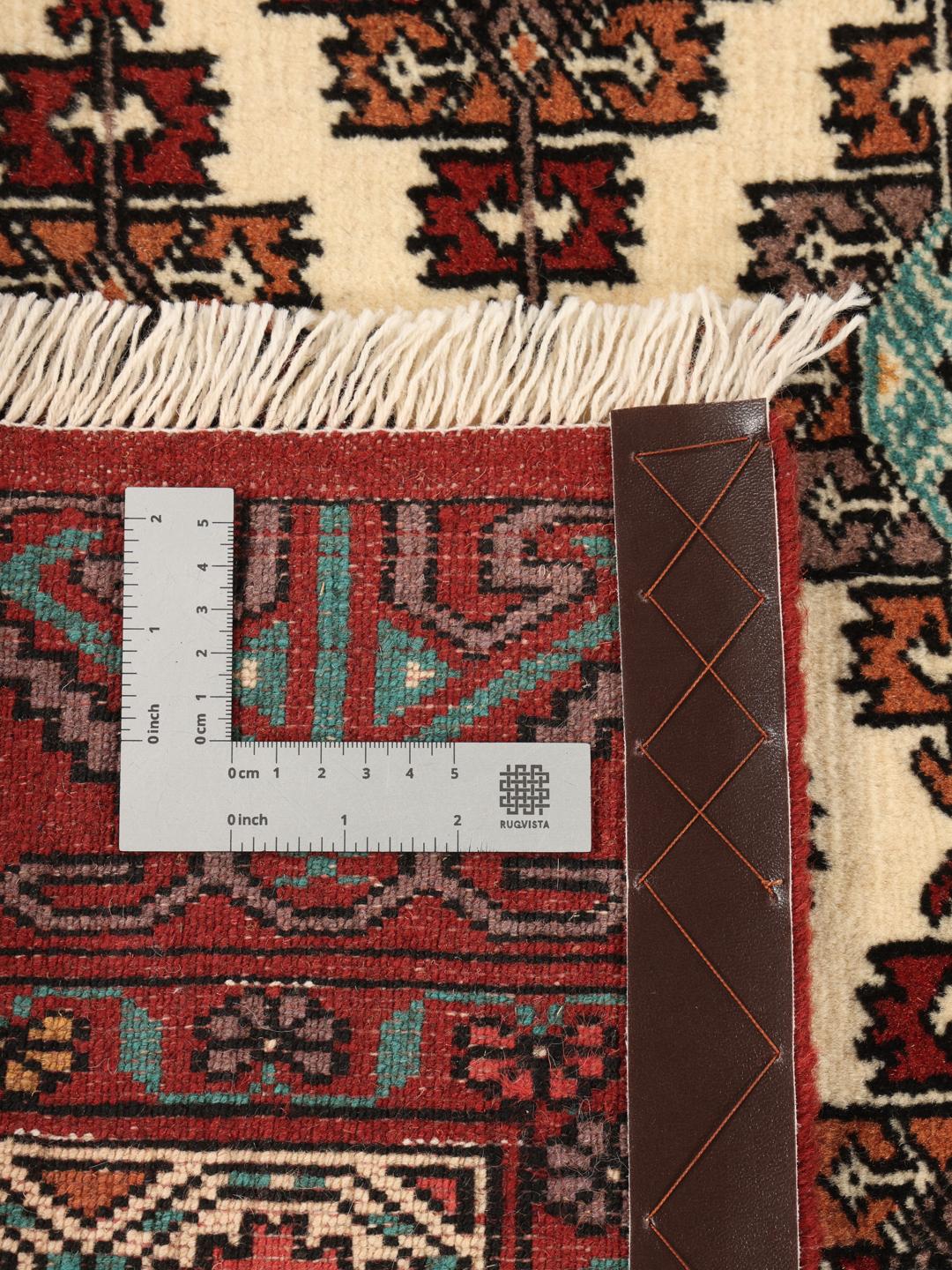 Hand-knotted Turkaman runner rug from the Middle East in red and beige tones.