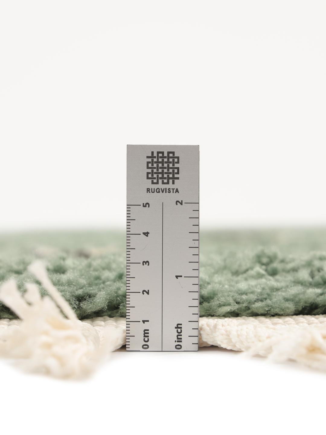 Groen rond vloerkleed met bloemmotieven en franjes