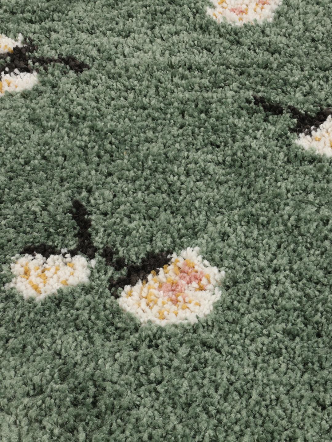 Grønt rundt tæppe med blomstermotiver og franser
