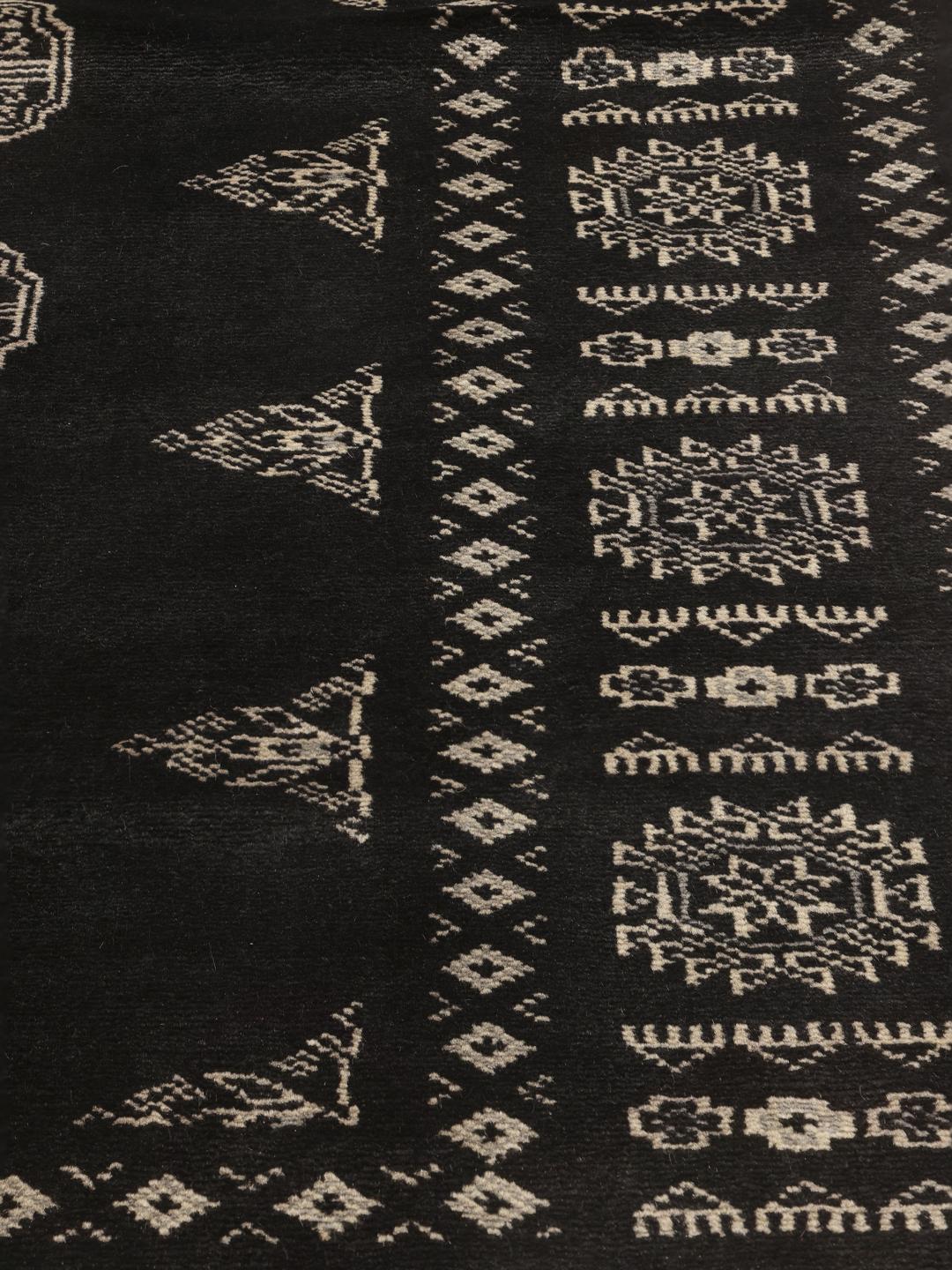 Hand-knotted Pakistan Bokhara rug with black field and geometric motifs