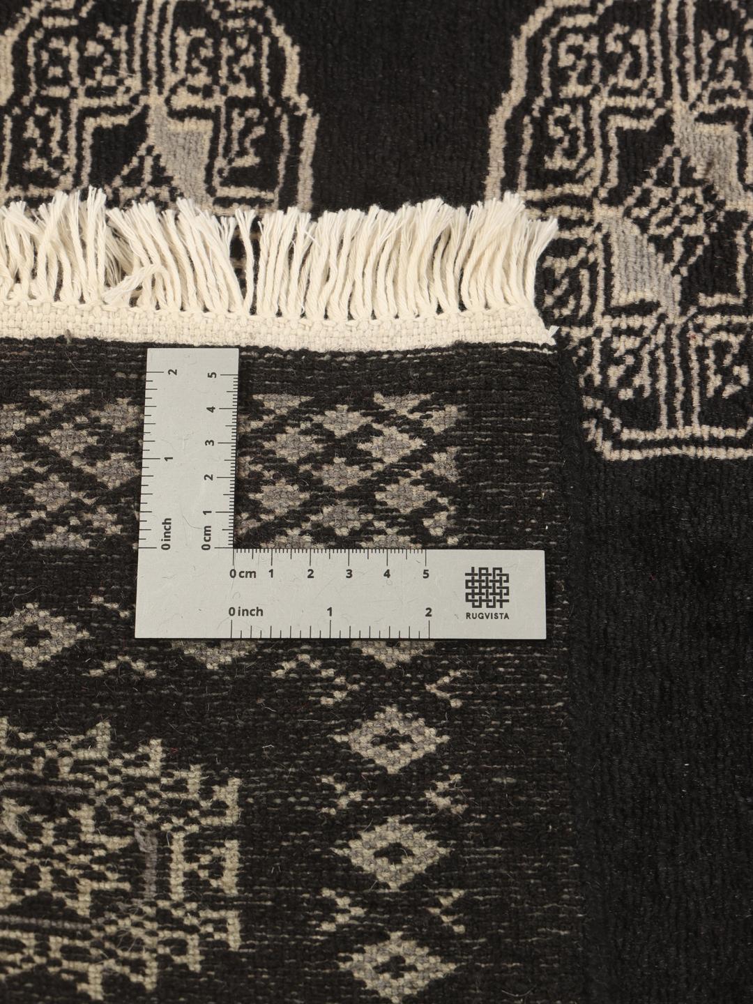 Hand-knotted Pakistan Bokhara rug with black field and geometric motifs