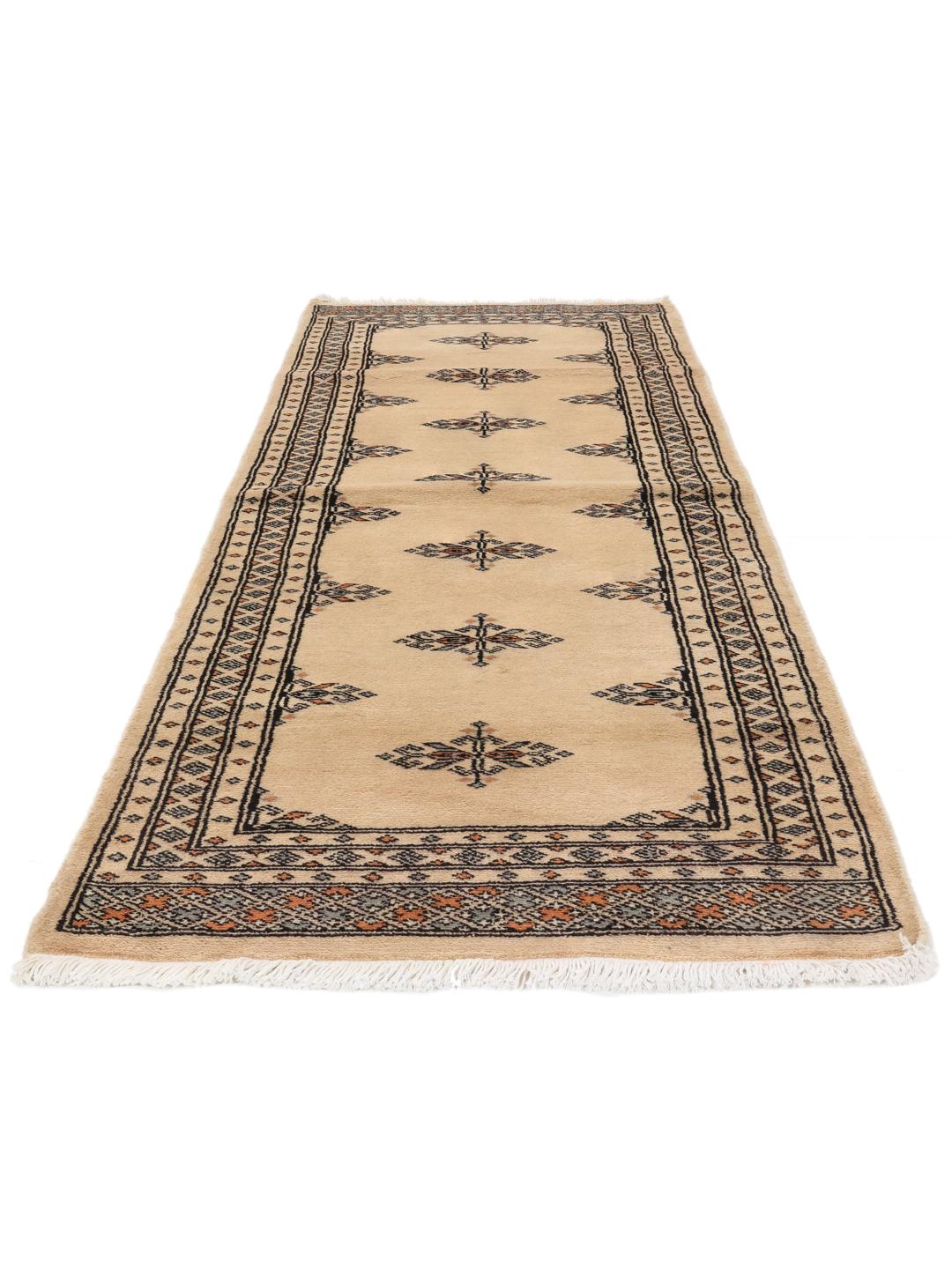 A hand-knotted Pakistani runner rug in beige with a traditional tribal pattern.