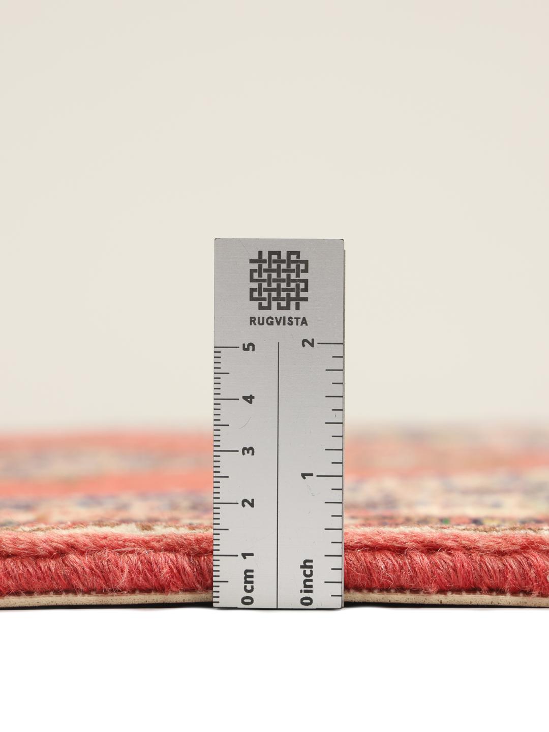 A hand-knotted Senneh rug from the Middle East in vibrant red tones.