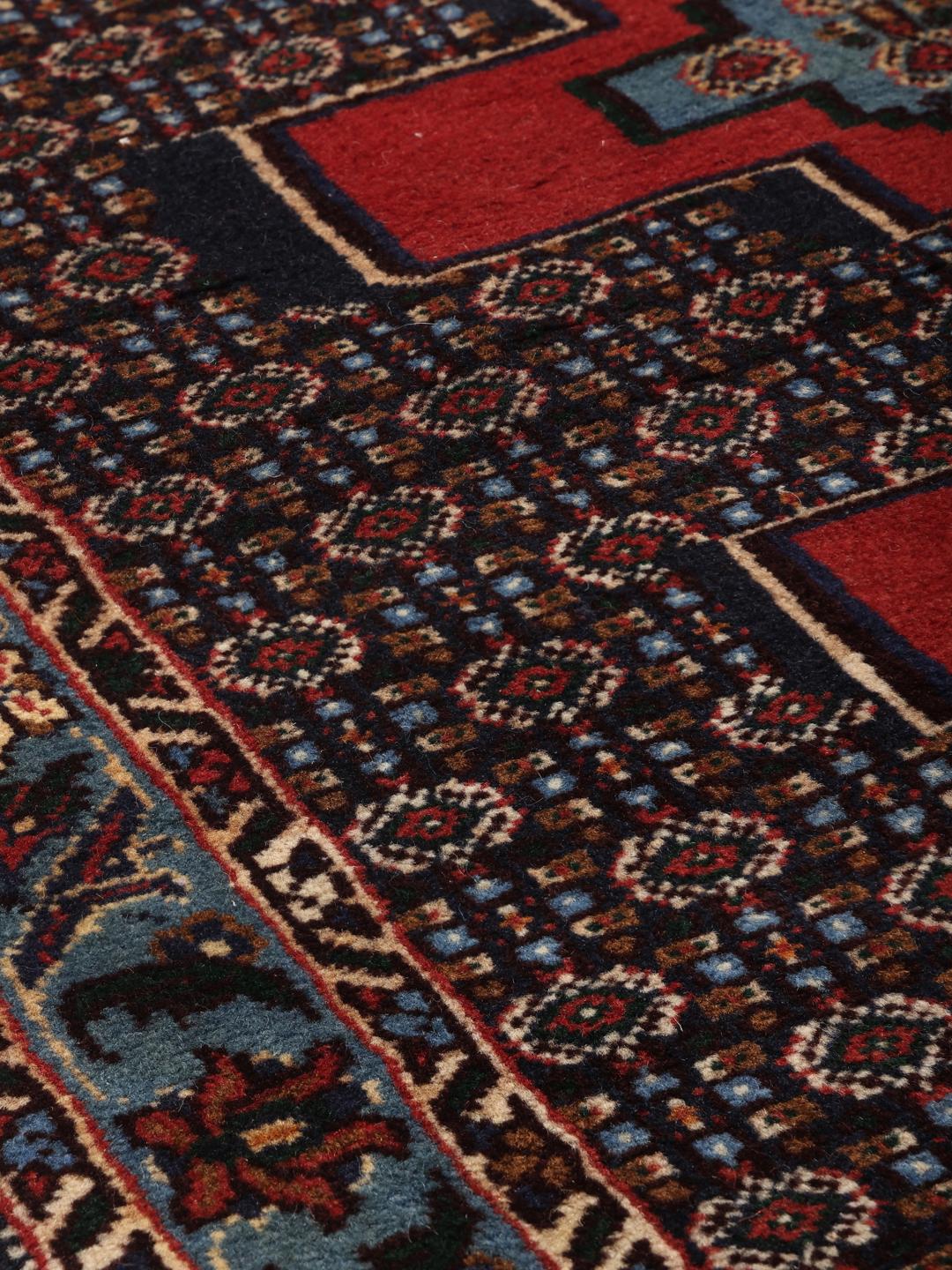 Hand-knotted Senneh runner with a geometric pattern in red and blue tones from the Middle East