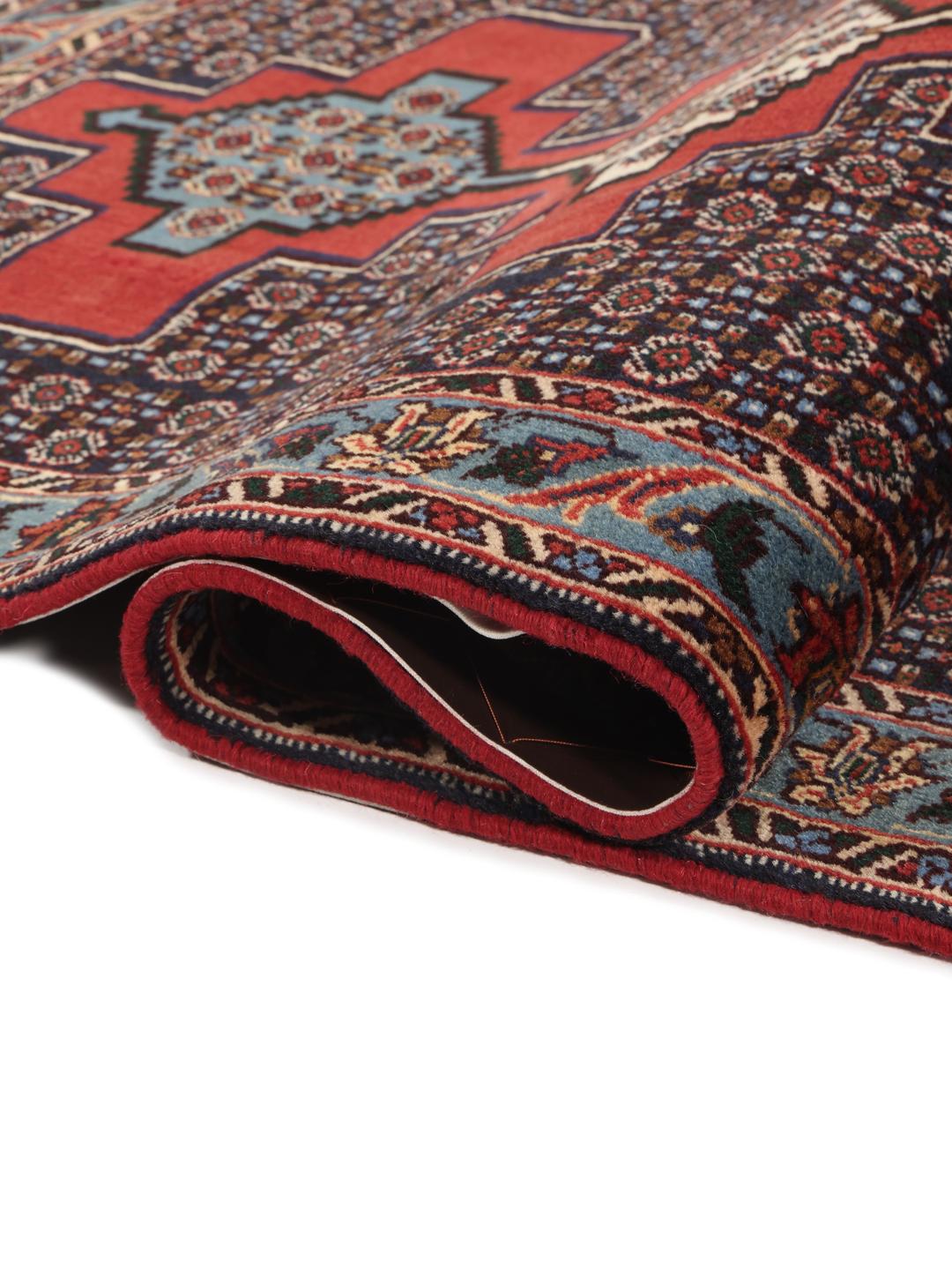 Hand-knotted Senneh runner with a geometric pattern in red and blue tones from the Middle East