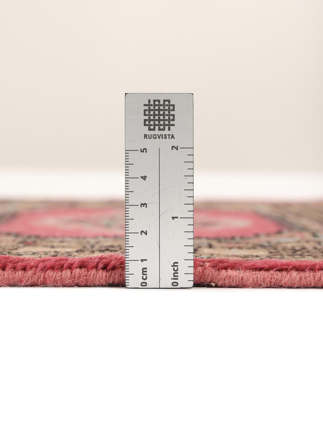 A small, rectangular Pakistan Bokhara 2ply rug in dark-red with geometric medallions.