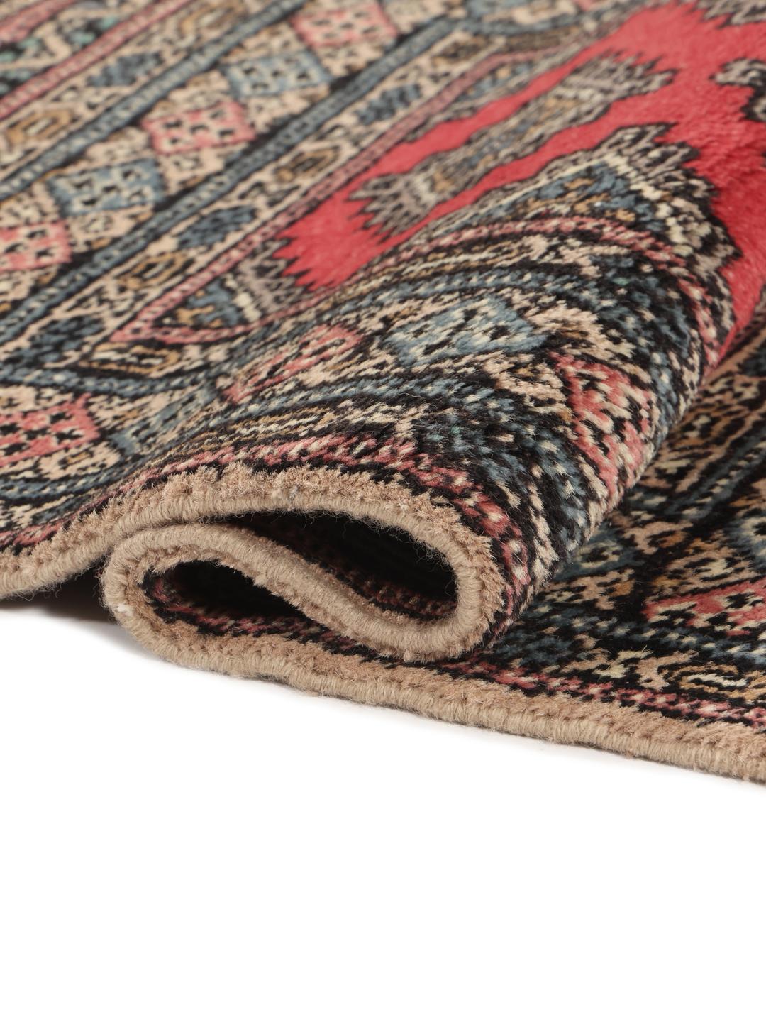 Hand-knotted Pakistan Bokhara rug in red with traditional geometric patterns