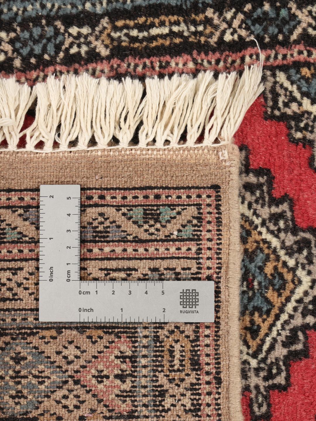 Hand-knotted Pakistan Bokhara rug in red with traditional geometric patterns