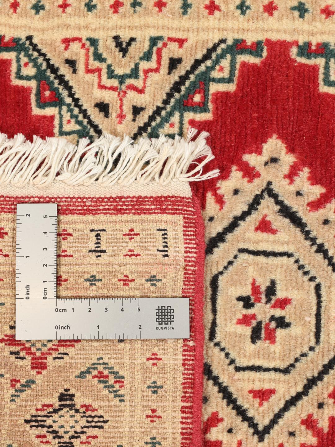 A hand-knotted Pakistan Bokhara rug in red and beige with geometric medallions