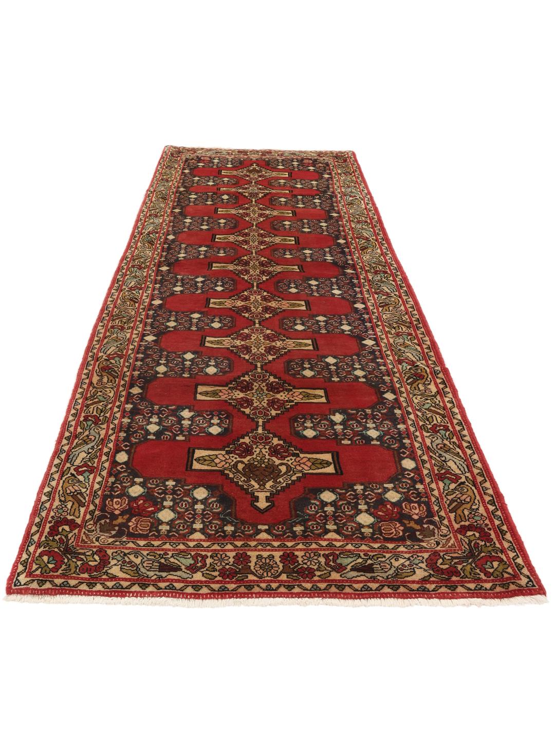 Hand-knotted Senneh runner from the Middle East in shades of red and dark blue.