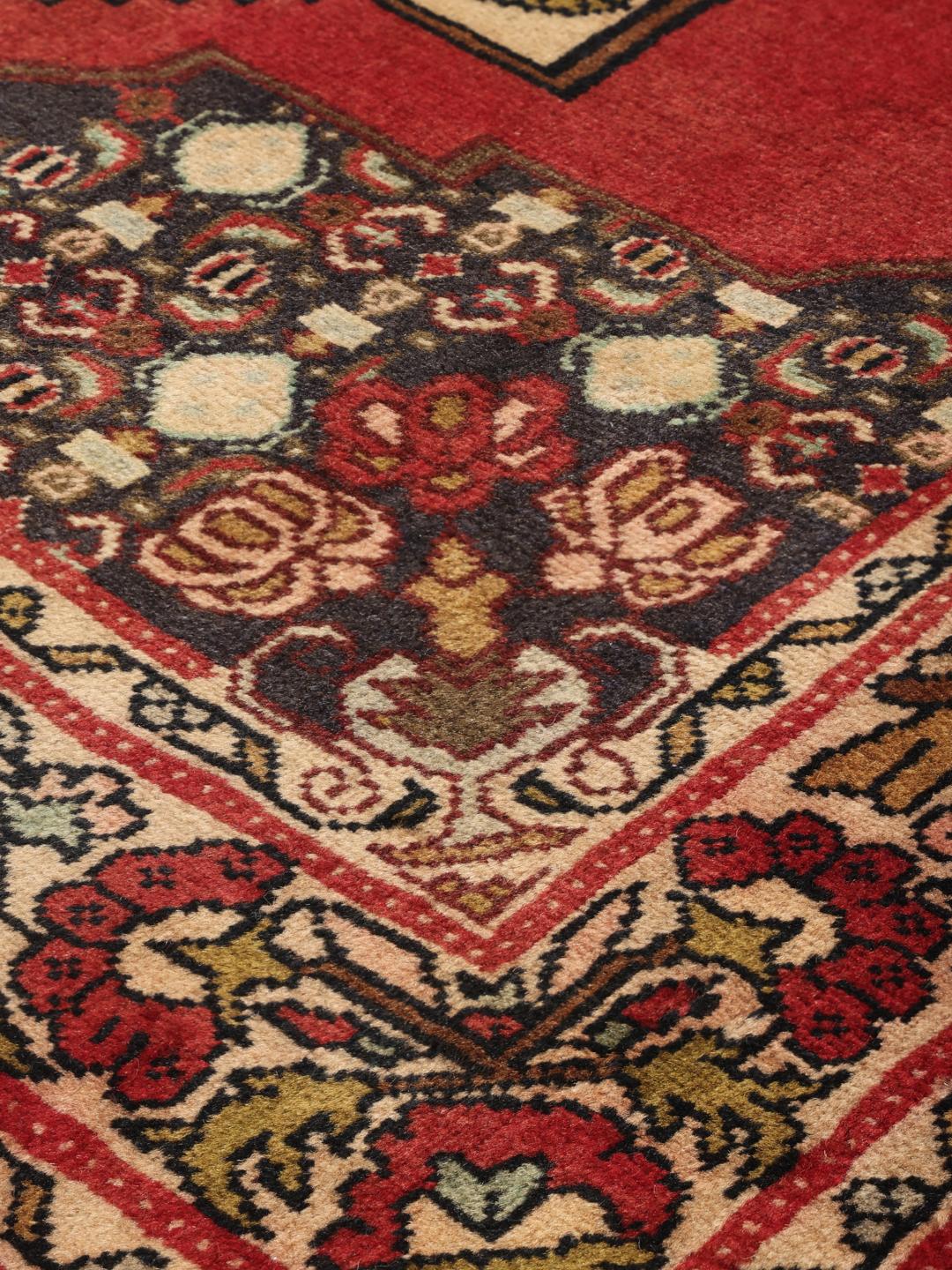 Hand-knotted Senneh runner from the Middle East in shades of red and dark blue.