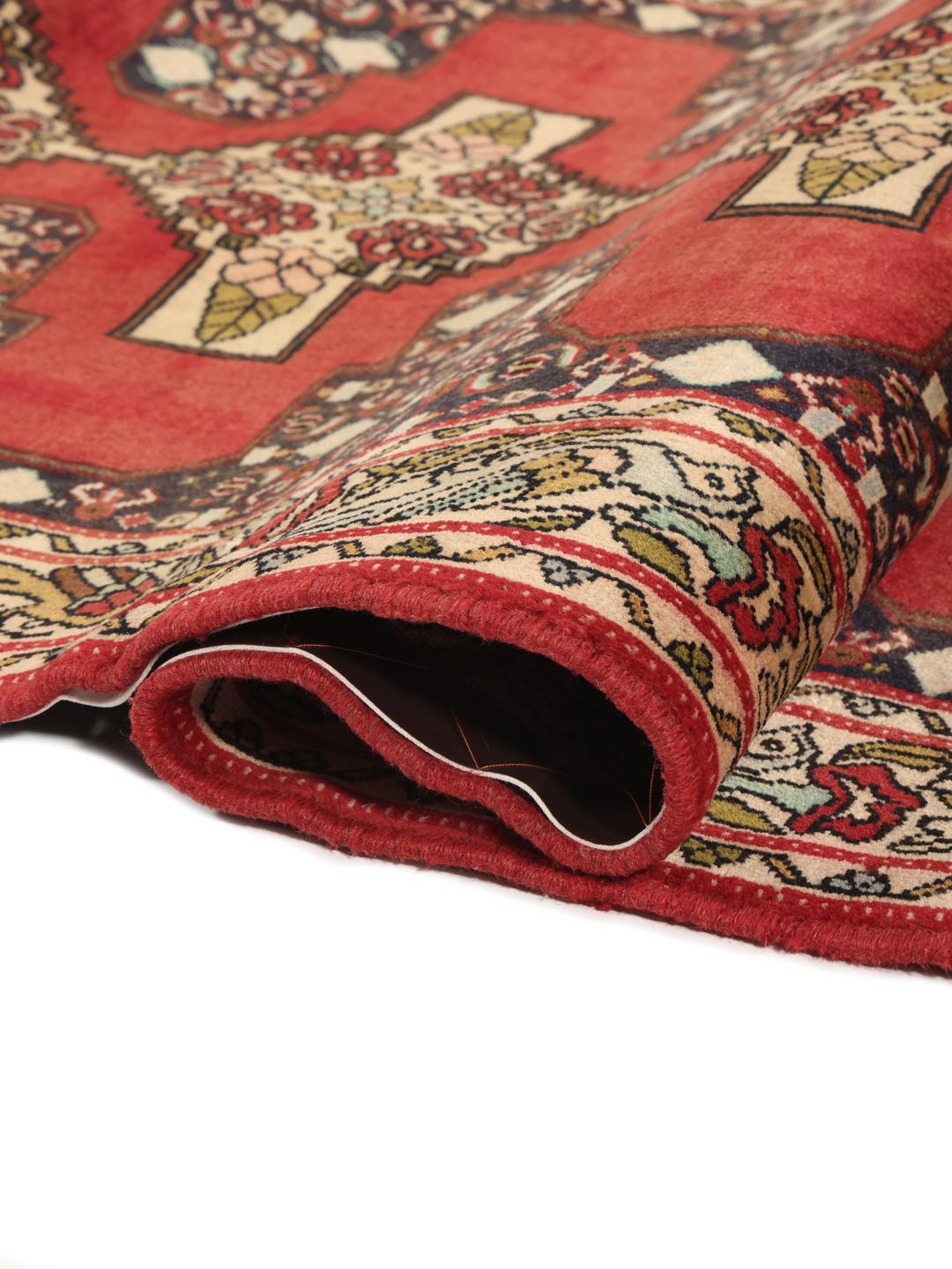 Hand-knotted Senneh runner from the Middle East in shades of red and dark blue.