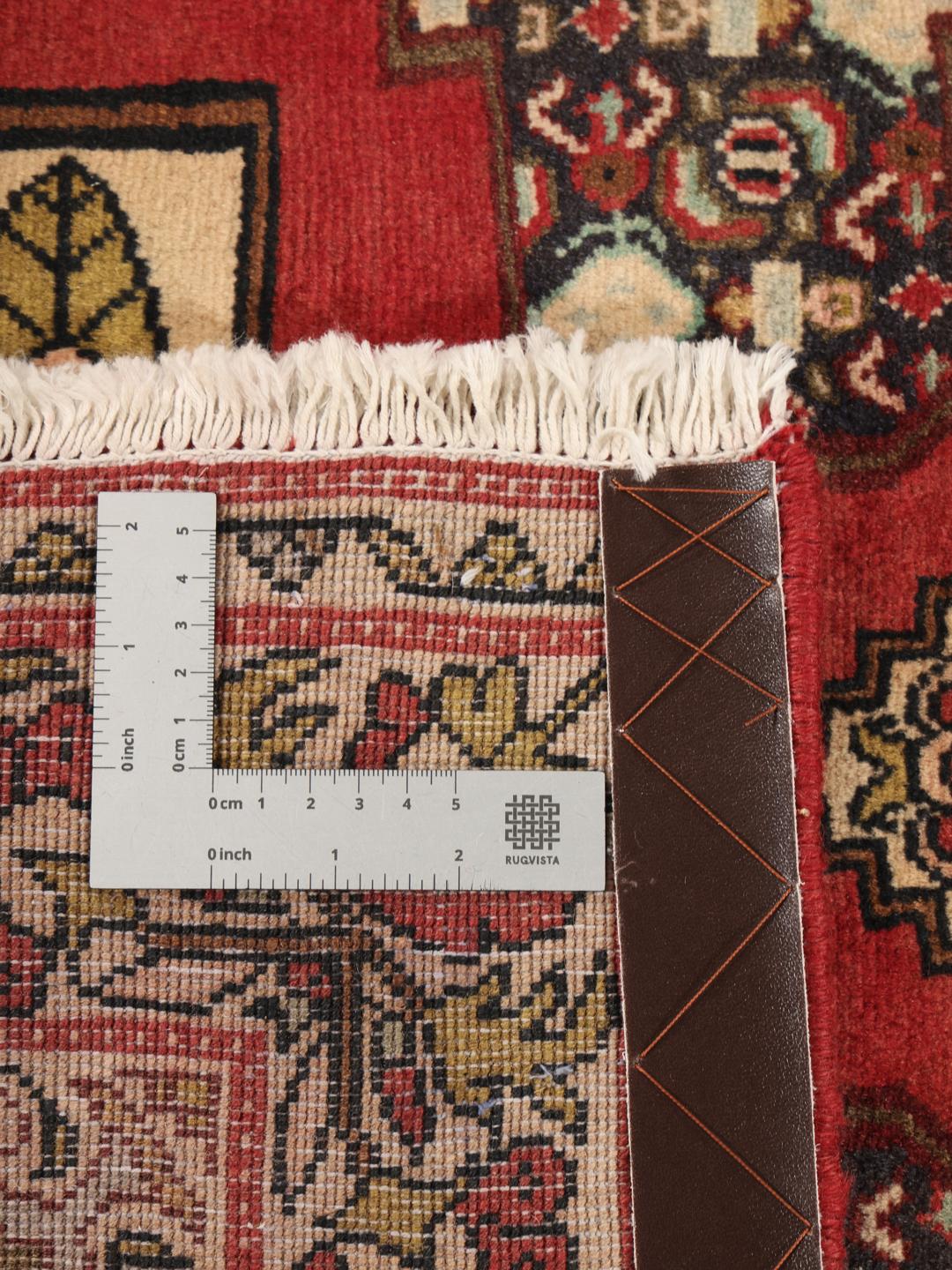 Hand-knotted Senneh runner from the Middle East in shades of red and dark blue.