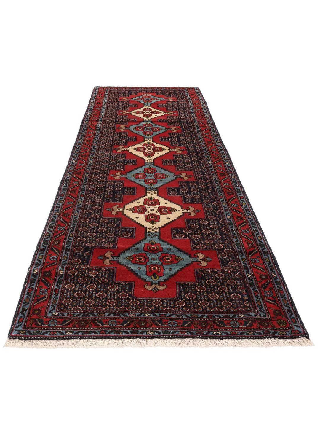 Hand-knotted Senneh runner with a red field and decorative medallion pattern