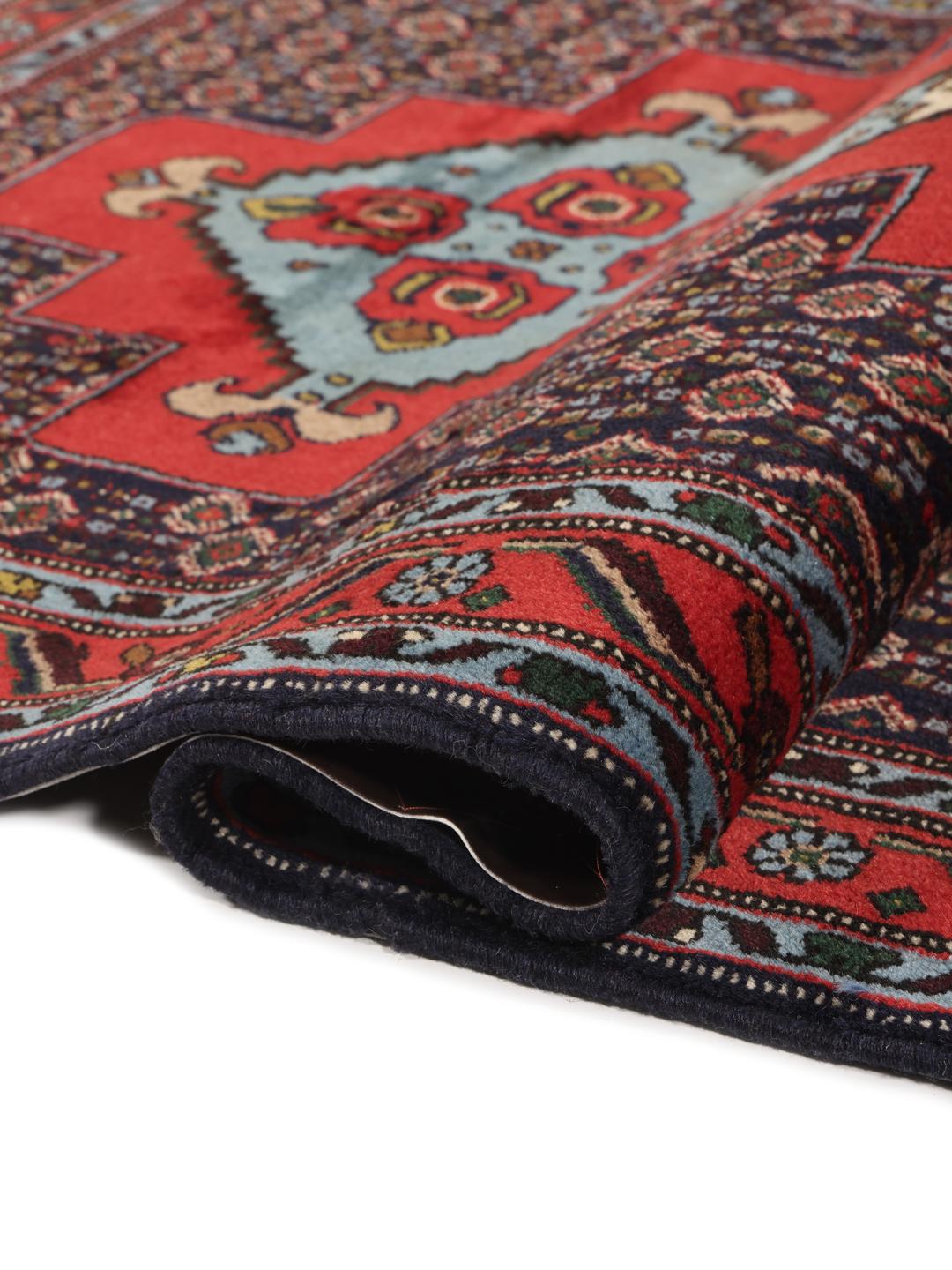 Hand-knotted Senneh runner with a red field and decorative medallion pattern