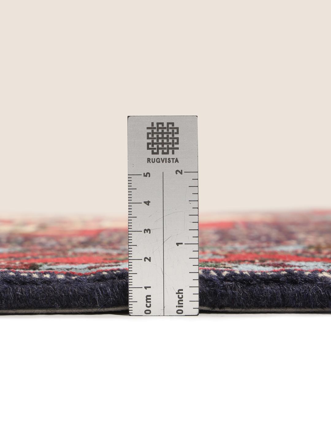 Hand-knotted Senneh runner with a red field and decorative medallion pattern