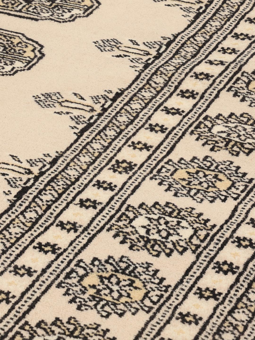 Hand-knotted beige Pakistan Bokhara rug with traditional repeating motifs