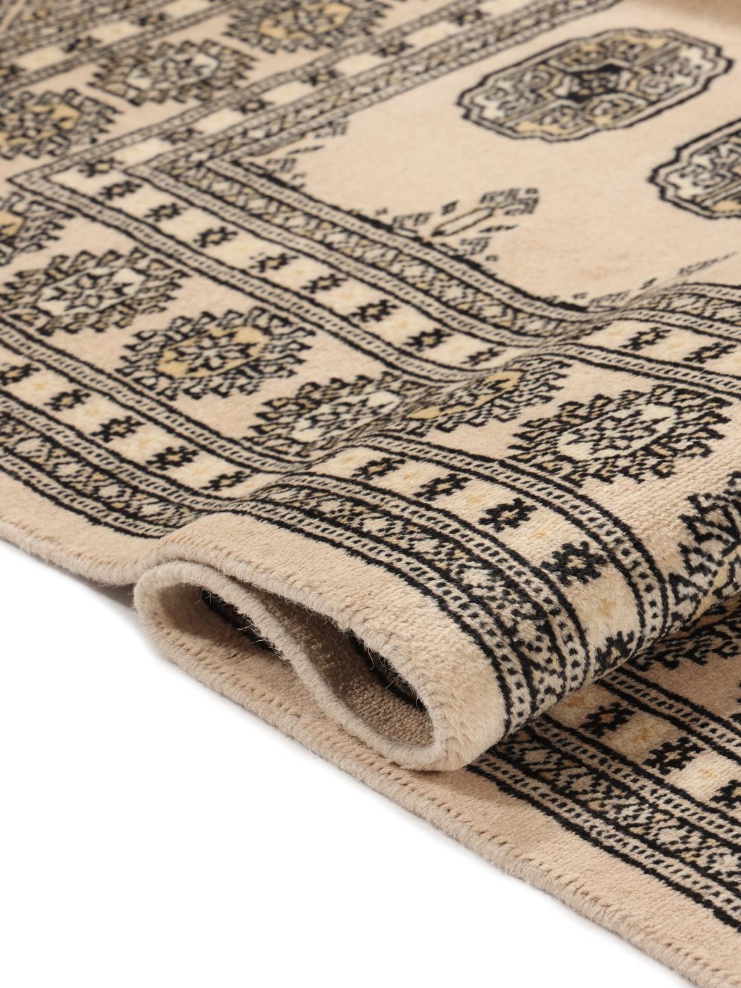 Hand-knotted beige Pakistan Bokhara rug with traditional repeating motifs