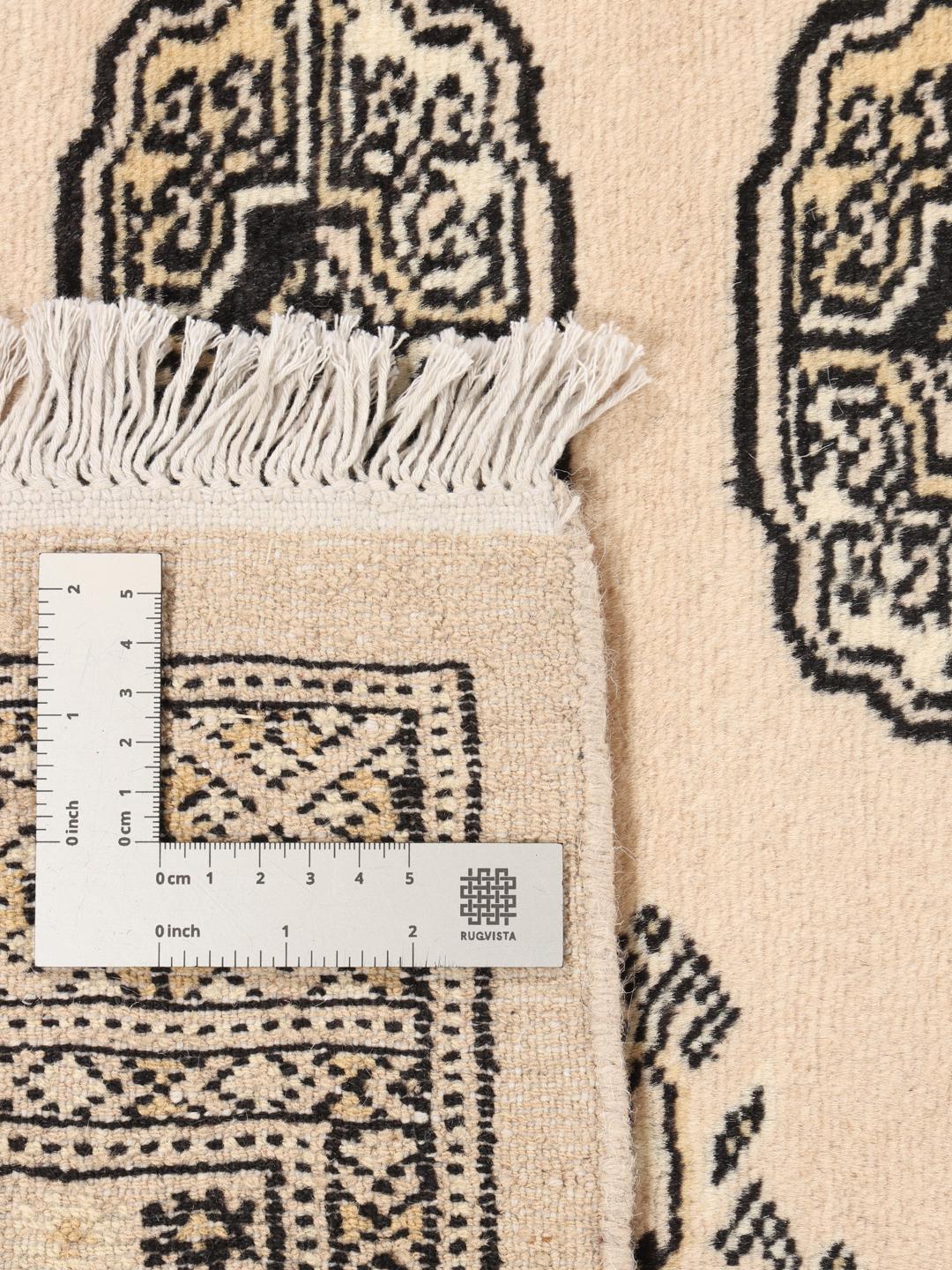 Hand-knotted beige Pakistan Bokhara rug with traditional repeating motifs