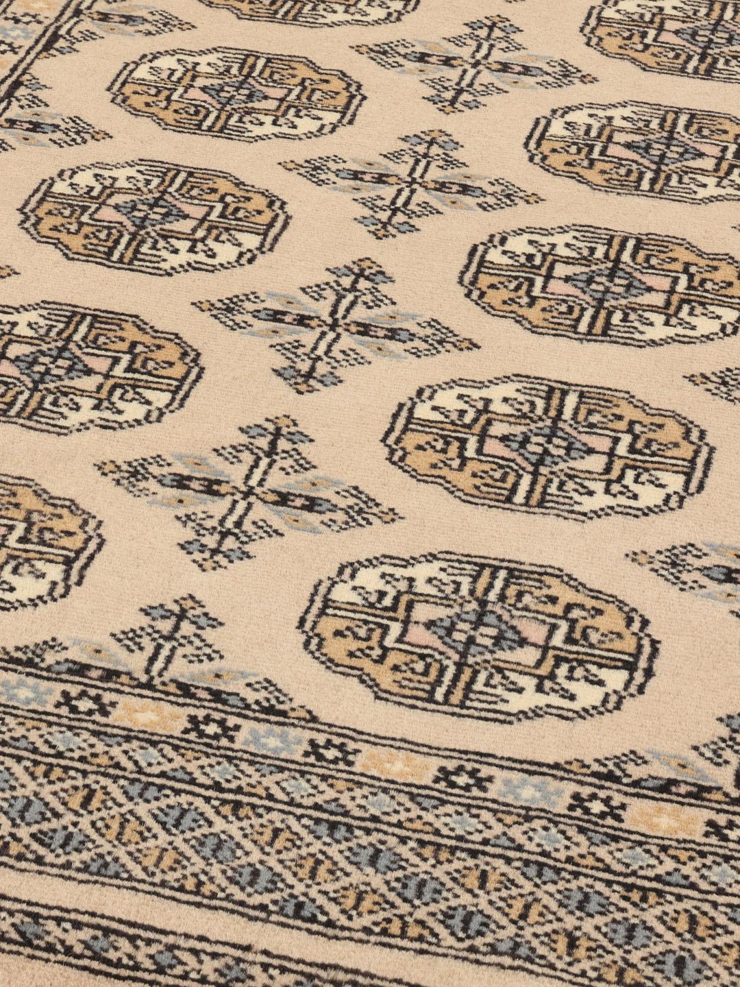 A hand-knotted beige Pakistan Bokhara 2ply rug with traditional geometric motifs.