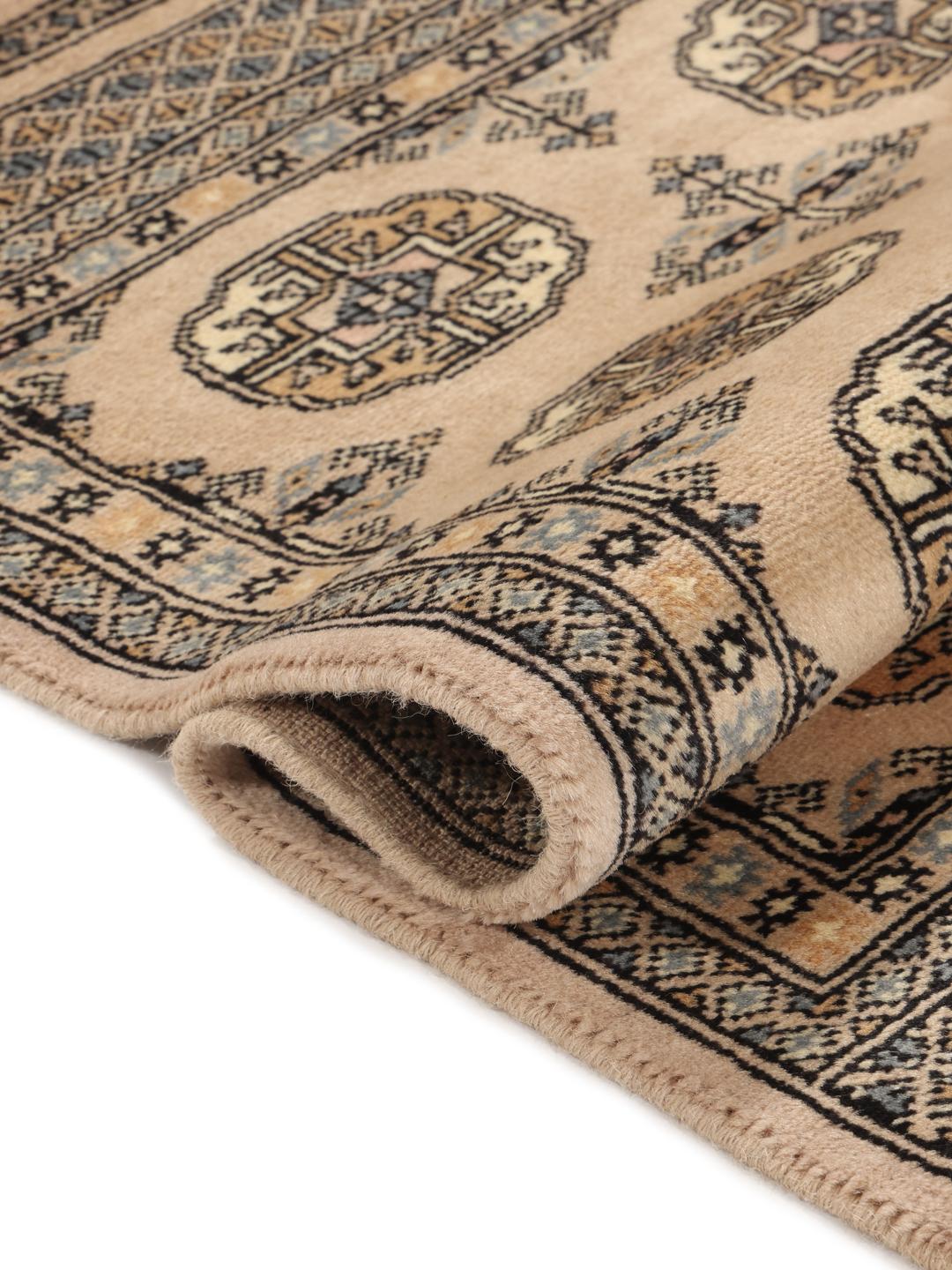 A hand-knotted beige Pakistan Bokhara 2ply rug with traditional geometric motifs.