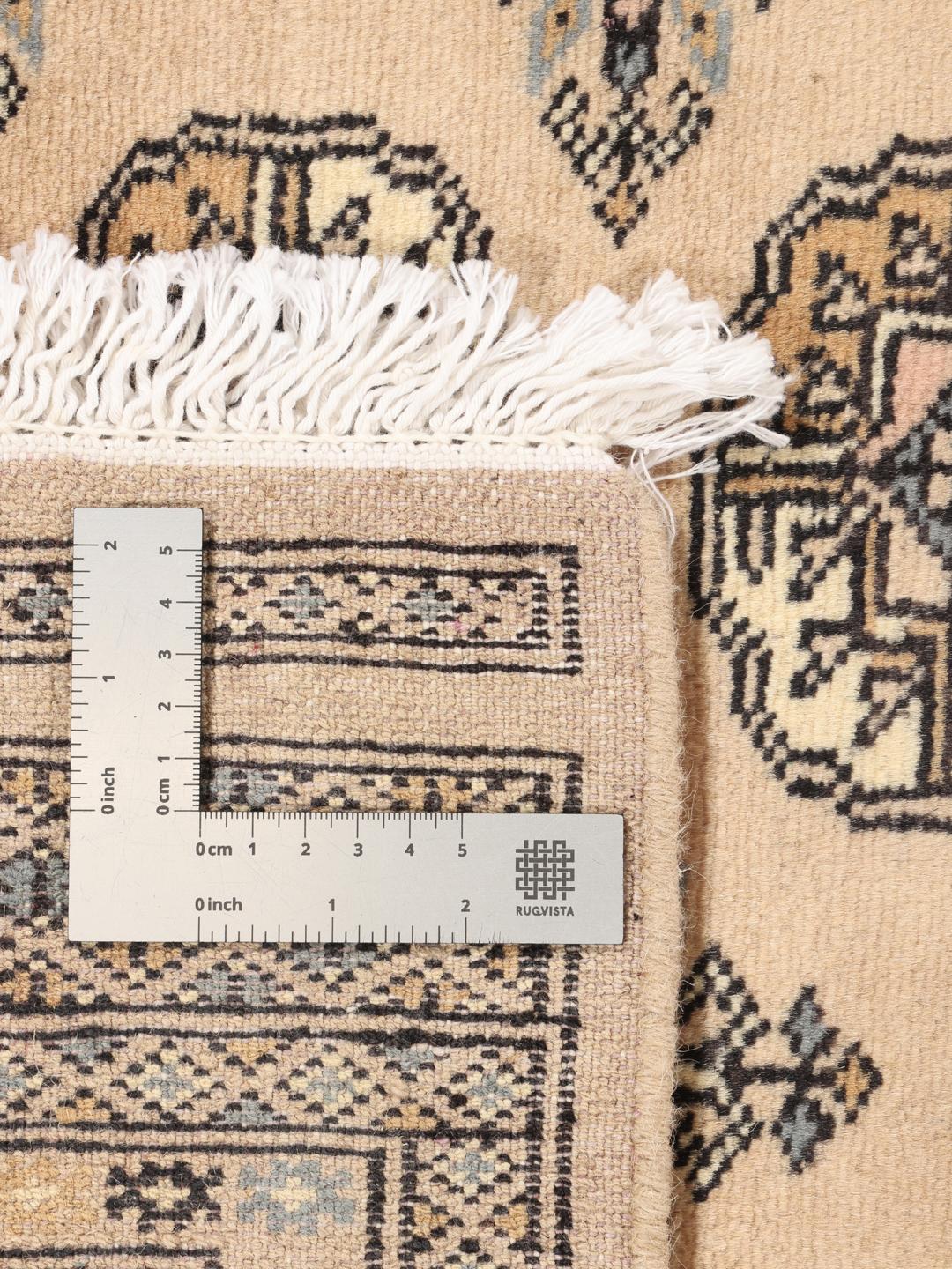 A hand-knotted beige Pakistan Bokhara 2ply rug with traditional geometric motifs.