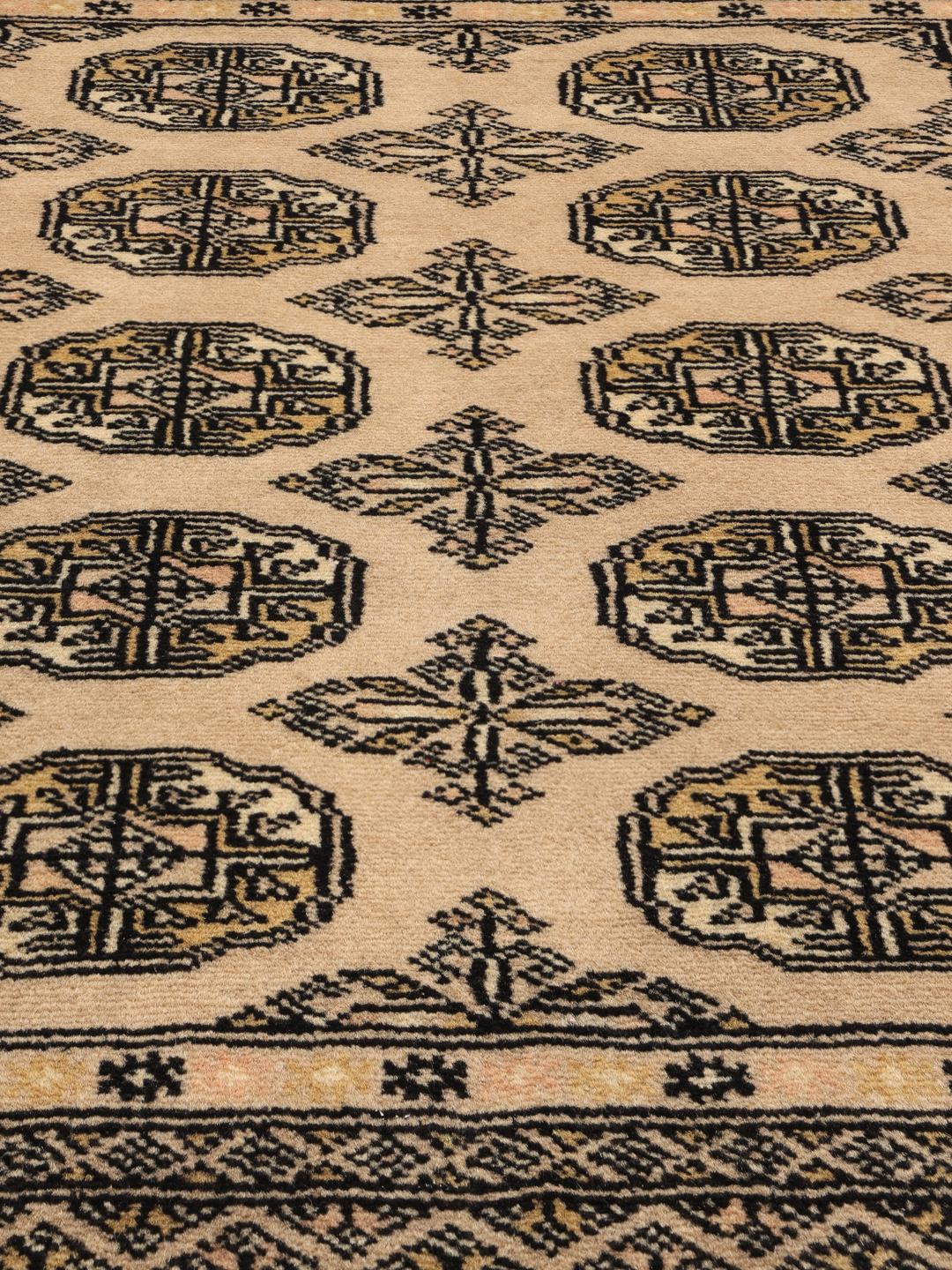 Hand-knotted beige Pakistan Bokhara rug with traditional medallion patterns