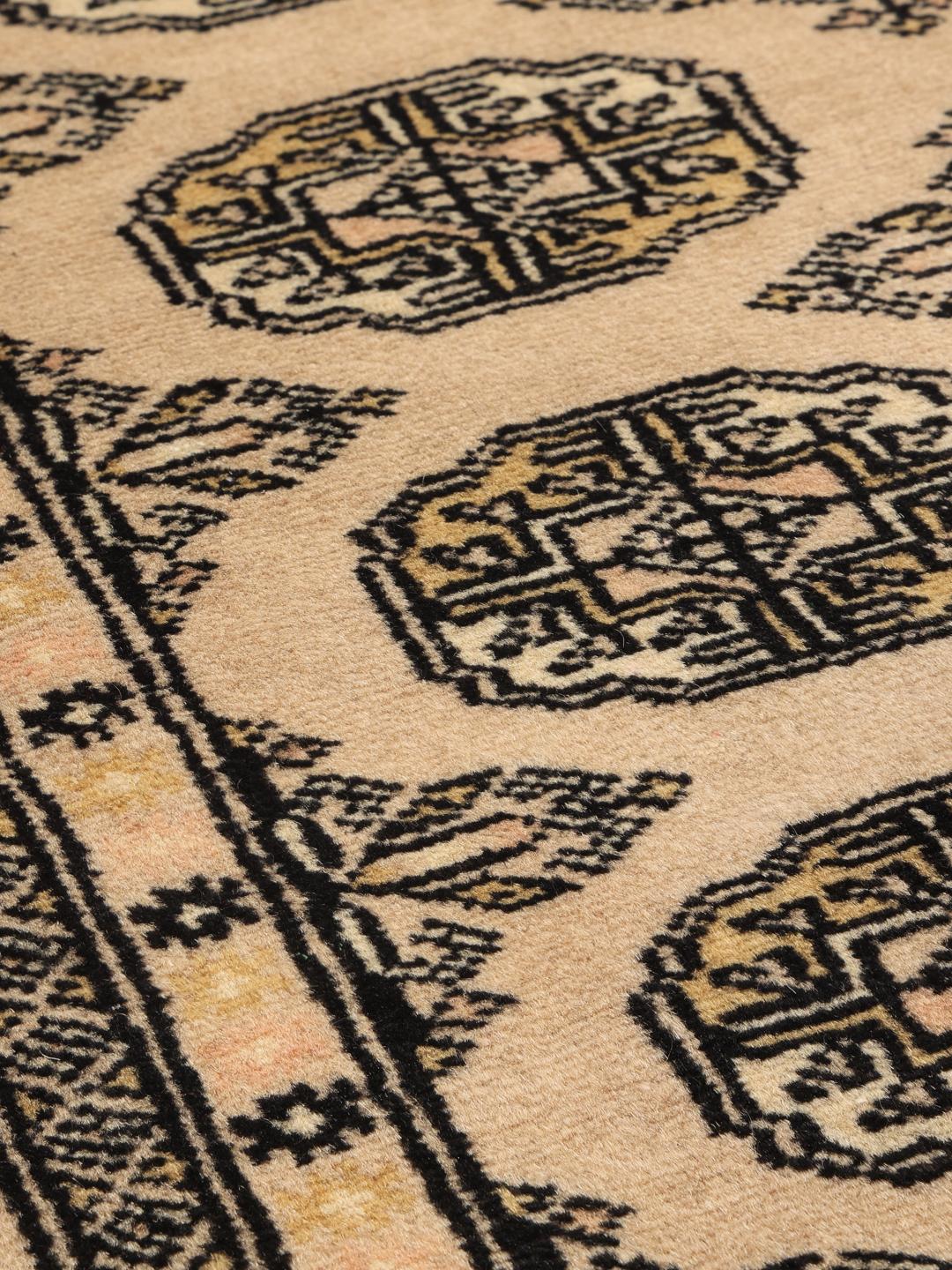 Hand-knotted beige Pakistan Bokhara rug with traditional medallion patterns