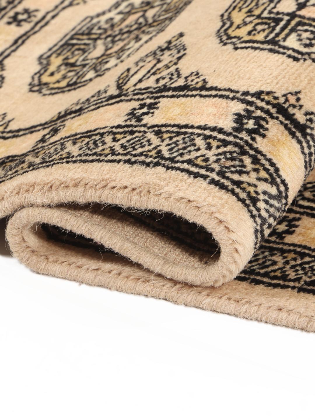 Hand-knotted beige Pakistan Bokhara rug with traditional medallion patterns
