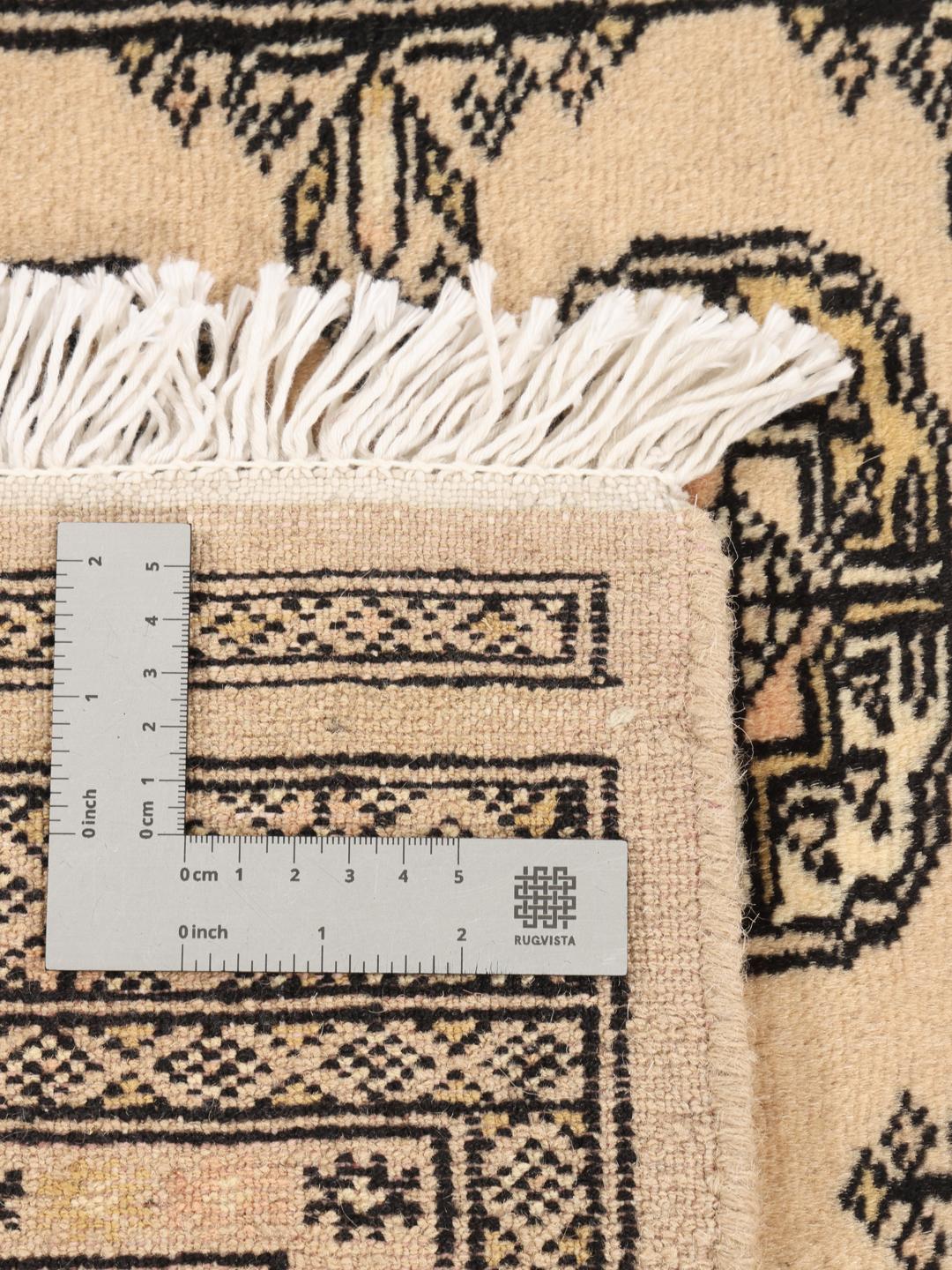 Hand-knotted beige Pakistan Bokhara rug with traditional medallion patterns