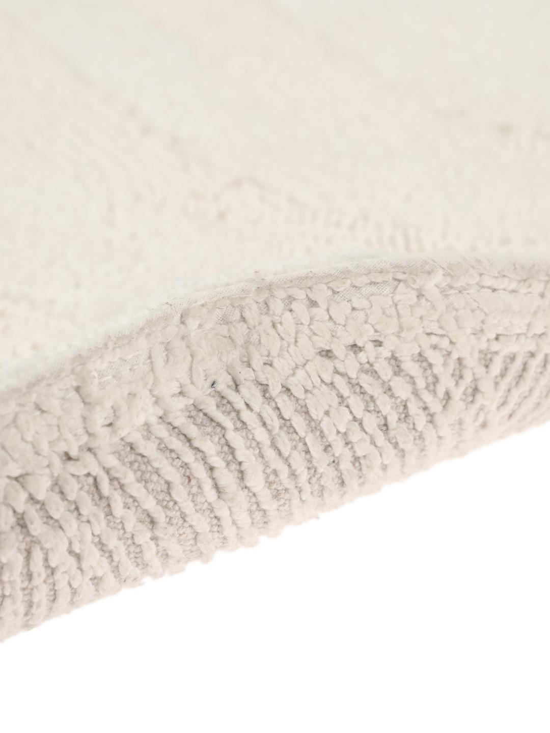 Tapis de bain rond blanc avec un motif de vagues texturé