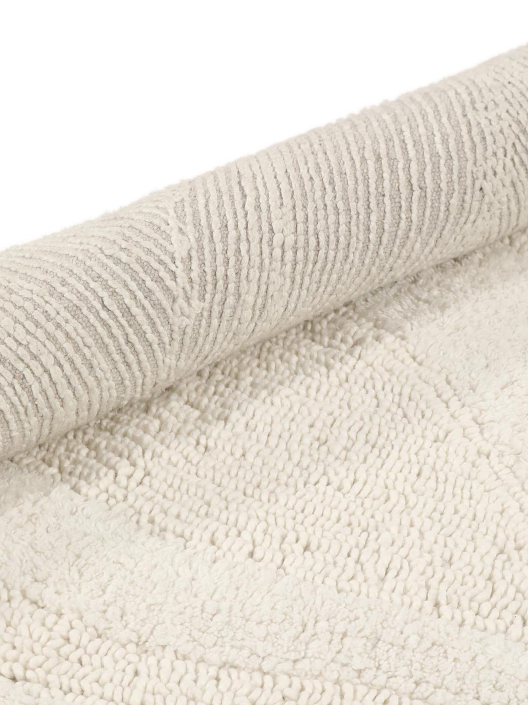 Tapis de bain rond blanc avec un motif de vagues texturé