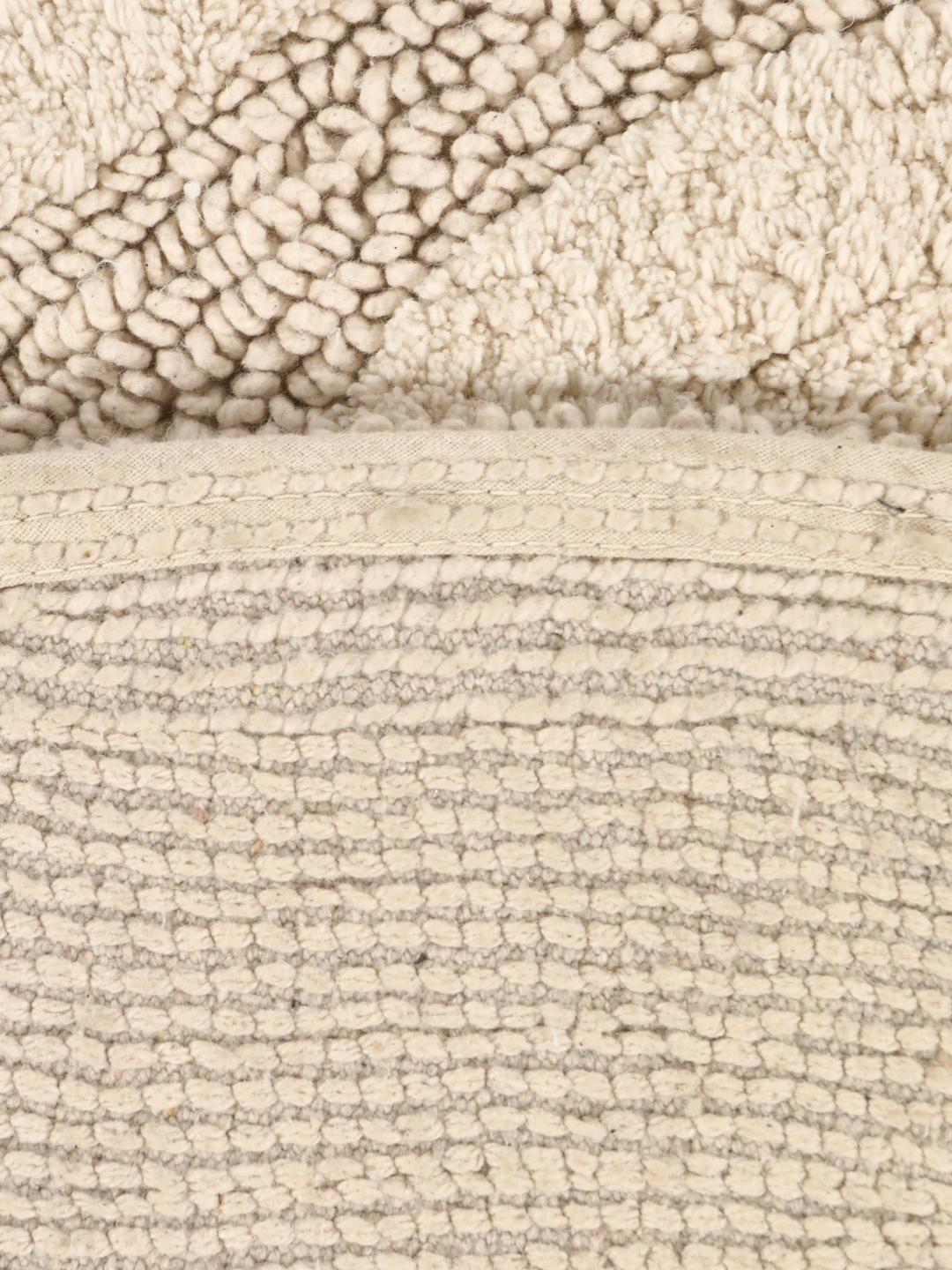 Rund beige bademåtte med et tekstureret bølget reliefmønster
