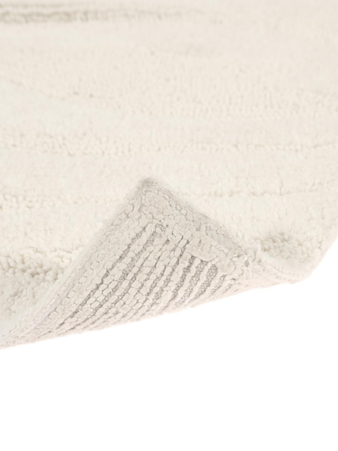 Witte badmat met een organisch verhoogd golfpatroon