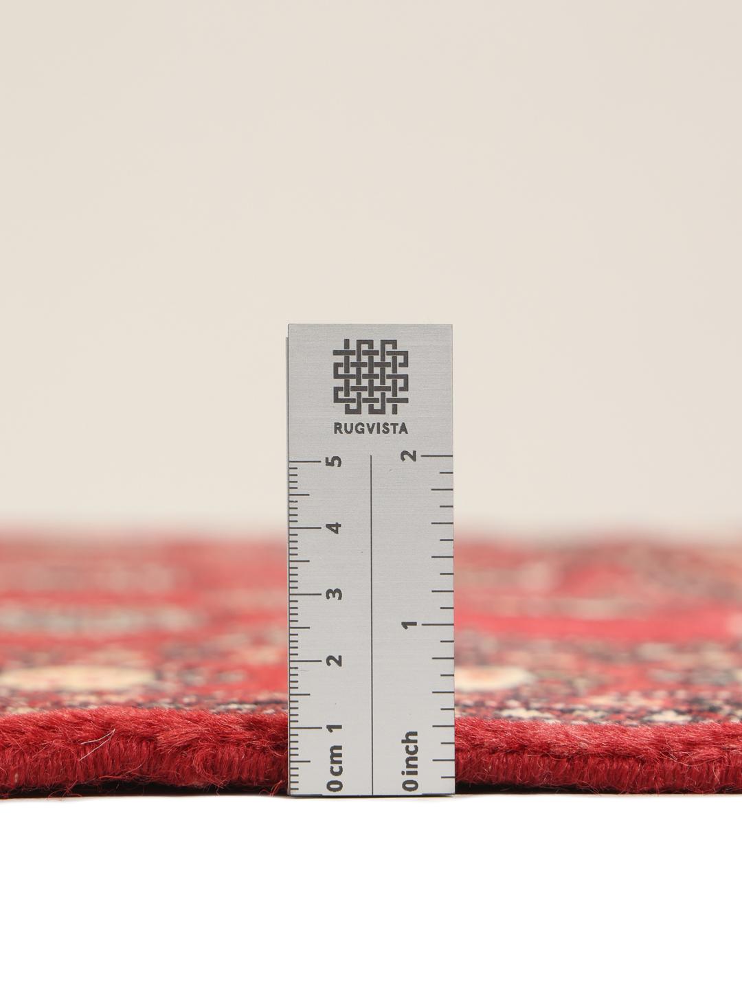Hand-knotted Pakistan Bokhara 2ply rug with a deep red field and traditional motifs