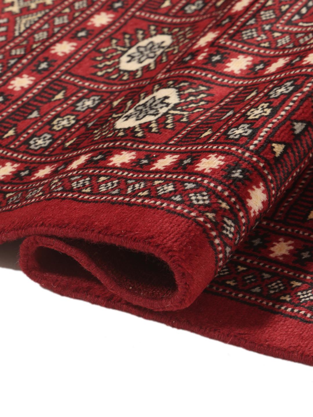 Hand-knotted Pakistan Bokhara rug in deep red with traditional gul motifs