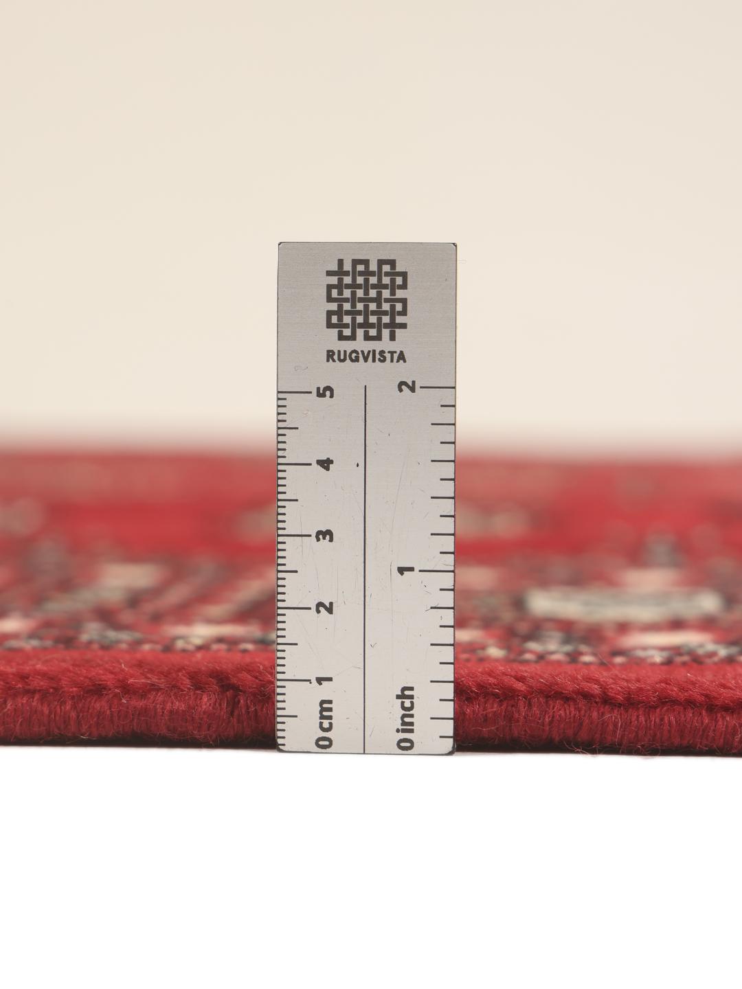 Hand-knotted Pakistan Bokhara rug in deep red with traditional gul motifs