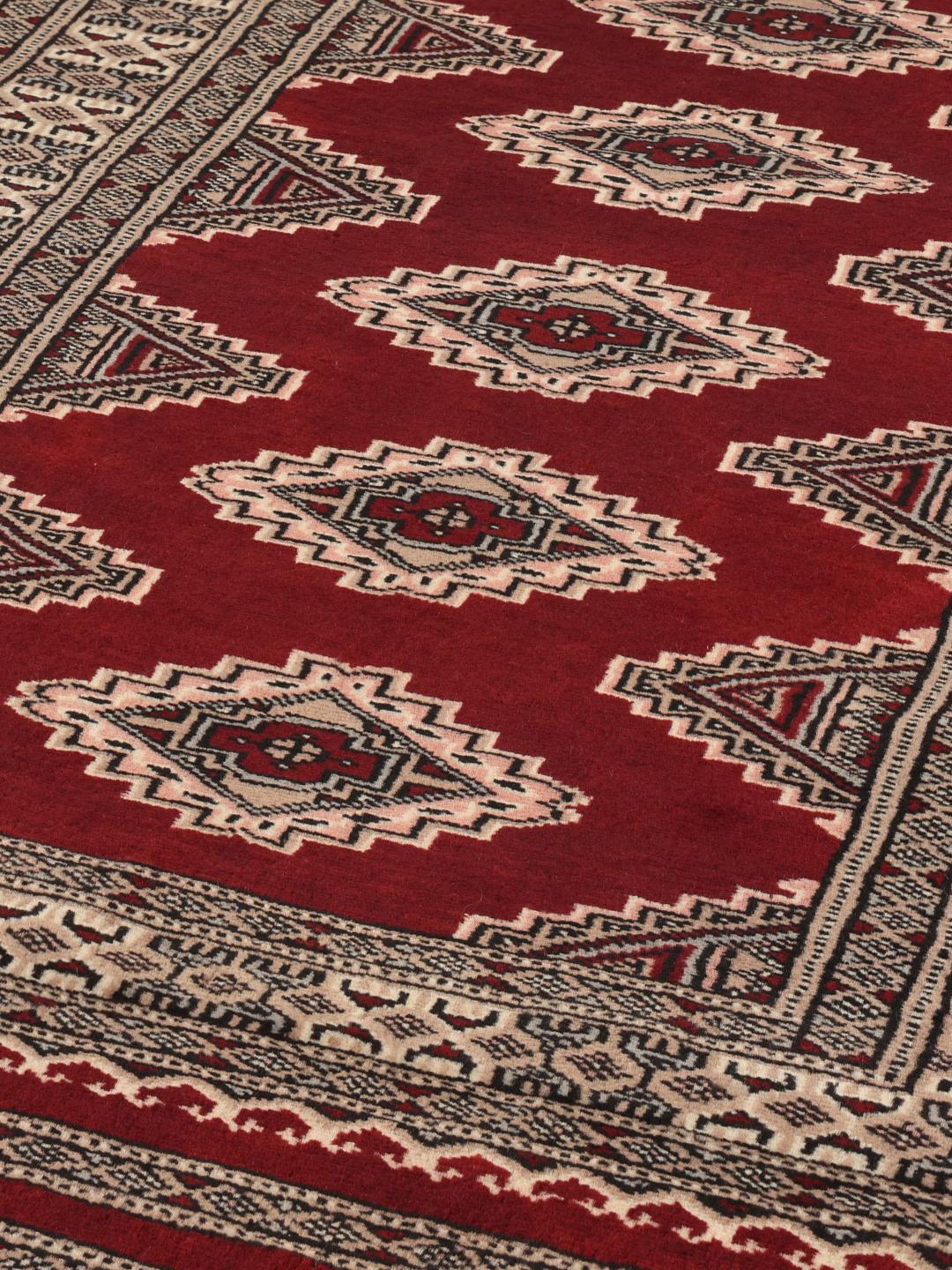 Hand-knotted Pakistan Bokhara rug in deep red with geometric medallions
