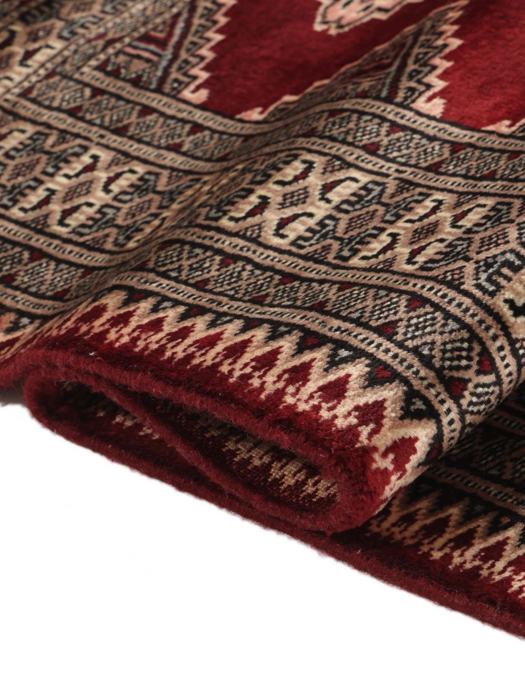 Hand-knotted Pakistan Bokhara rug in deep red with geometric medallions